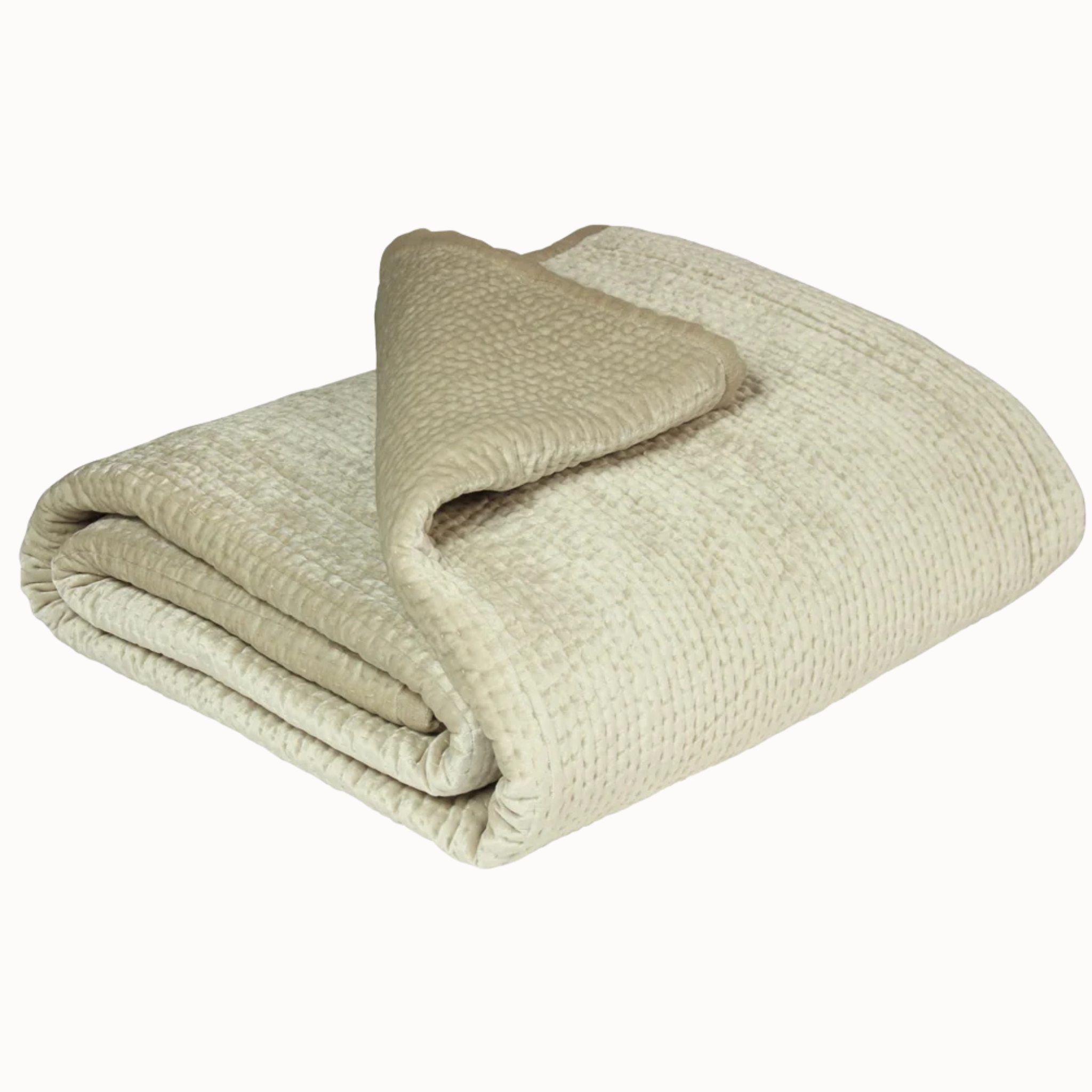 Émilie champagne quilted bedspread folded to show its textured finish and linen edging on a white background.