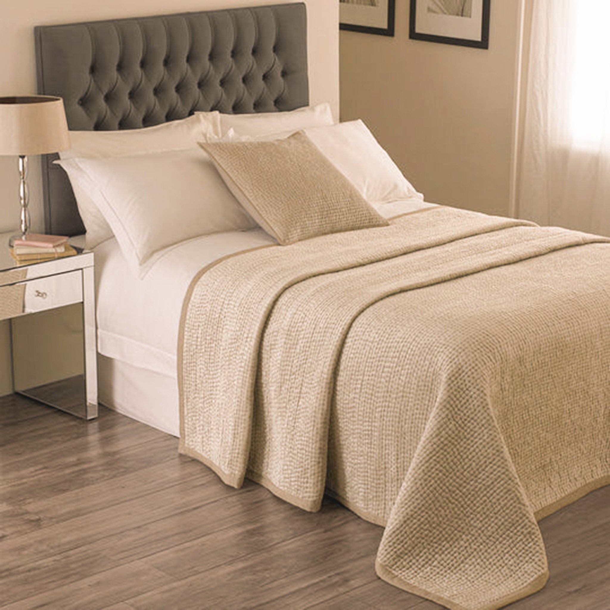 Émilie Quilted Champagne Bedspread with Linen Border styled on a double bed, featuring a softly textured quilted finish, neutral champagne tone and coordinating cushion.