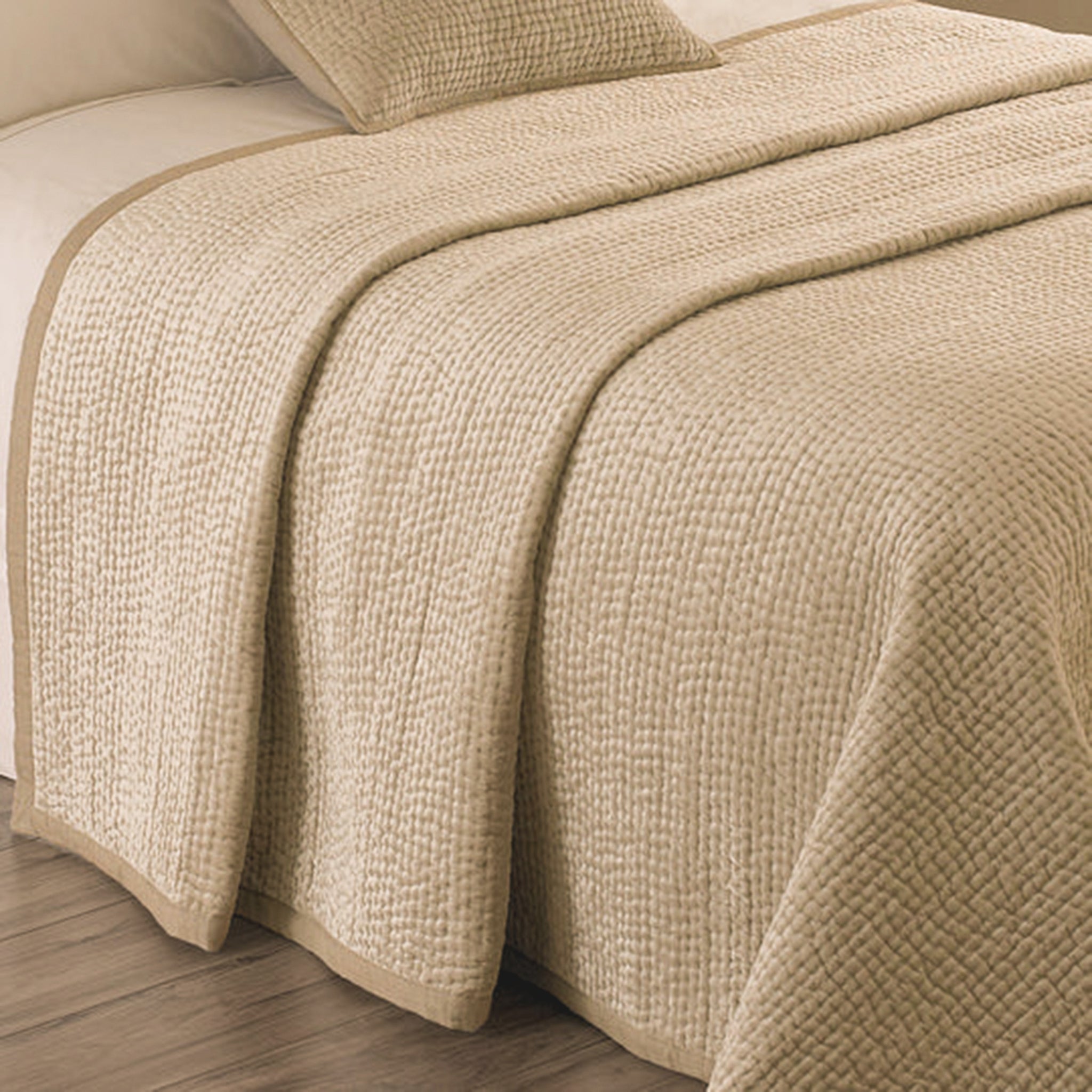 Close-up of the Émilie Quilted Champagne Bedspread with Linen Border, highlighting the tactile quilted texture, warm champagne colour and contrasting smooth linen edging.