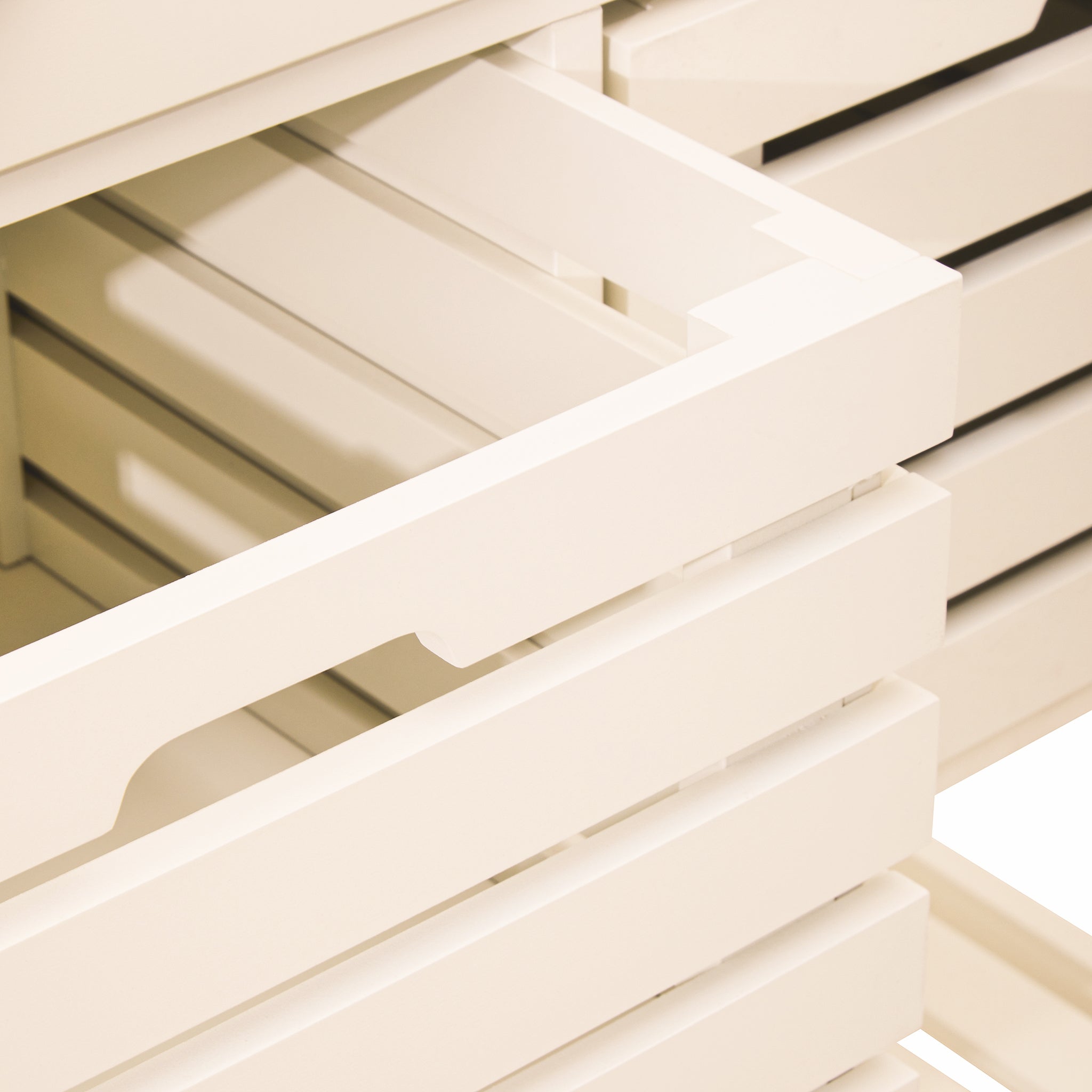 Close-up of the pull-out slatted storage baskets on the Étienne Cream Kitchen Trolley, highlighting the accessible removable-style kitchen storage beneath the drawers and stainless steel top.