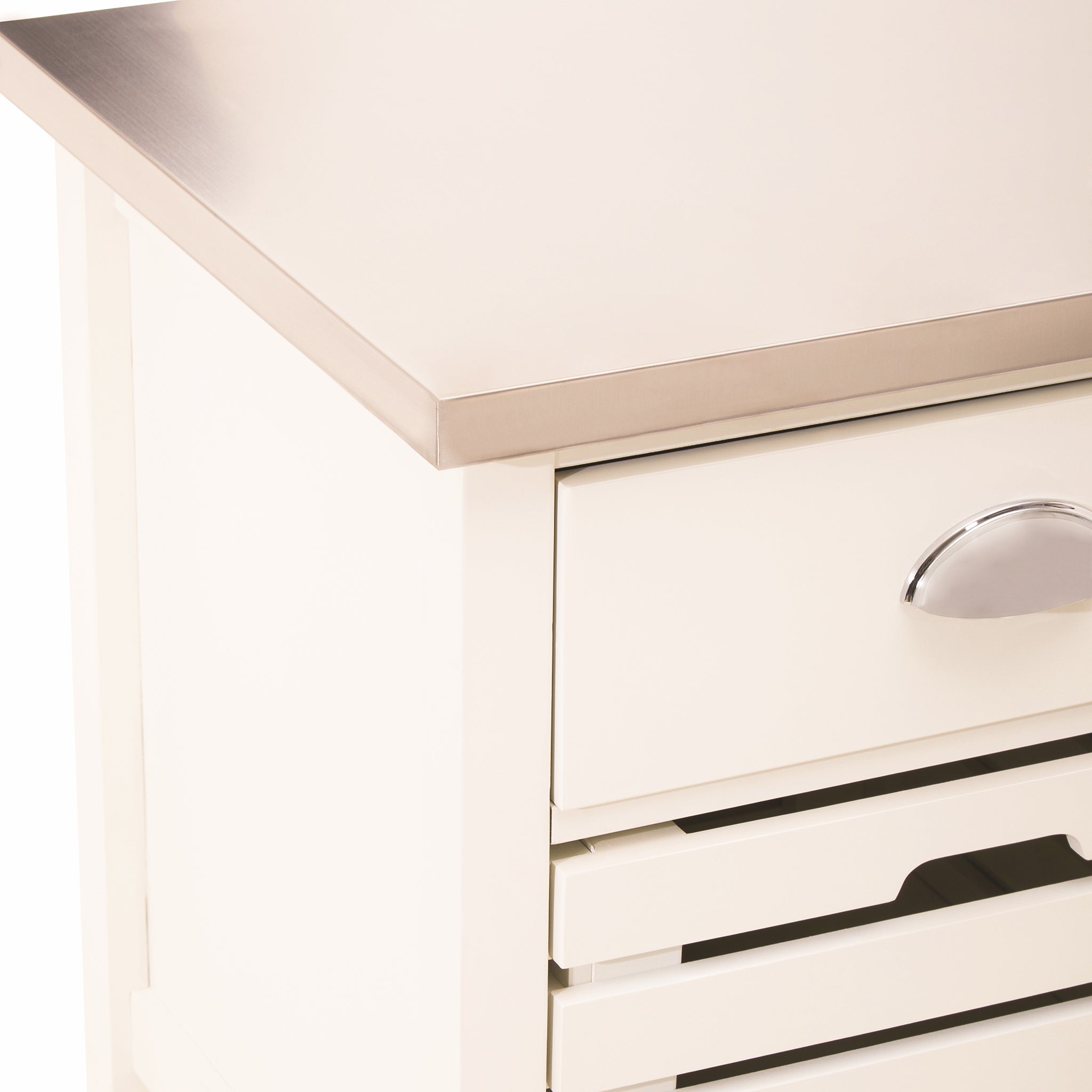 Close-up of the Étienne Cream Kitchen Trolley showing its stainless steel top, cream drawer with polished cup handle and slatted storage basket, highlighting the trolley's practical kitchen storage detailing.