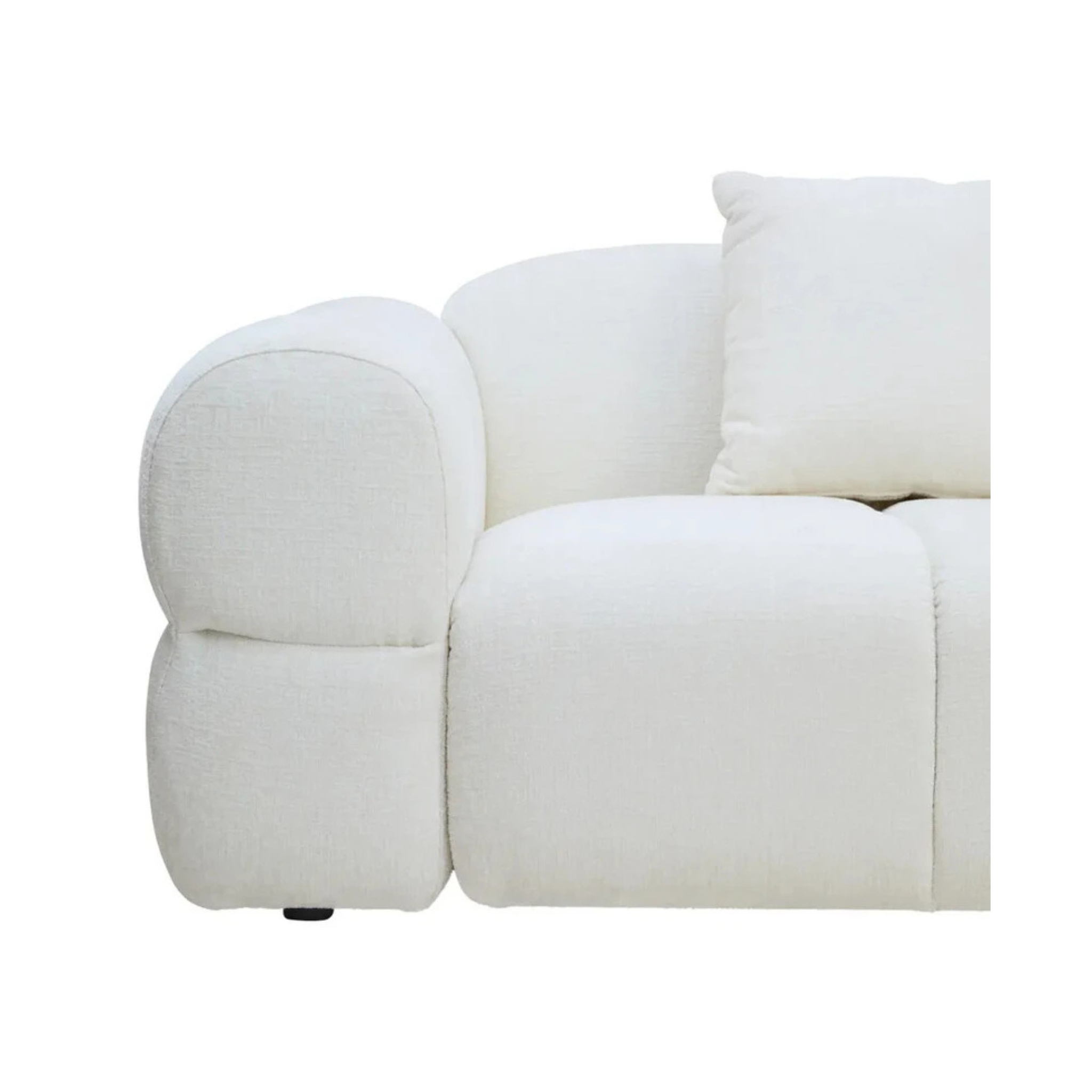 Éveline cream textured fabric sofa close-up showing its rounded padded arm, deep seat and cushion on a white background.