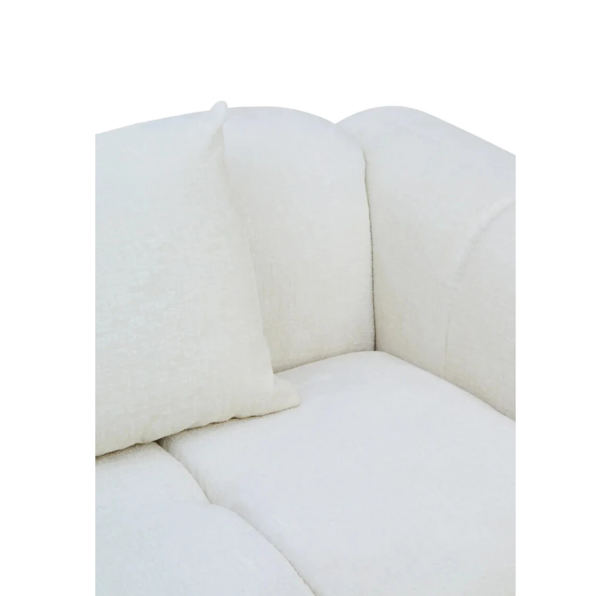 Éveline cream textured fabric sofa close-up showing deep padded seat, curved back and cushion on a white background.