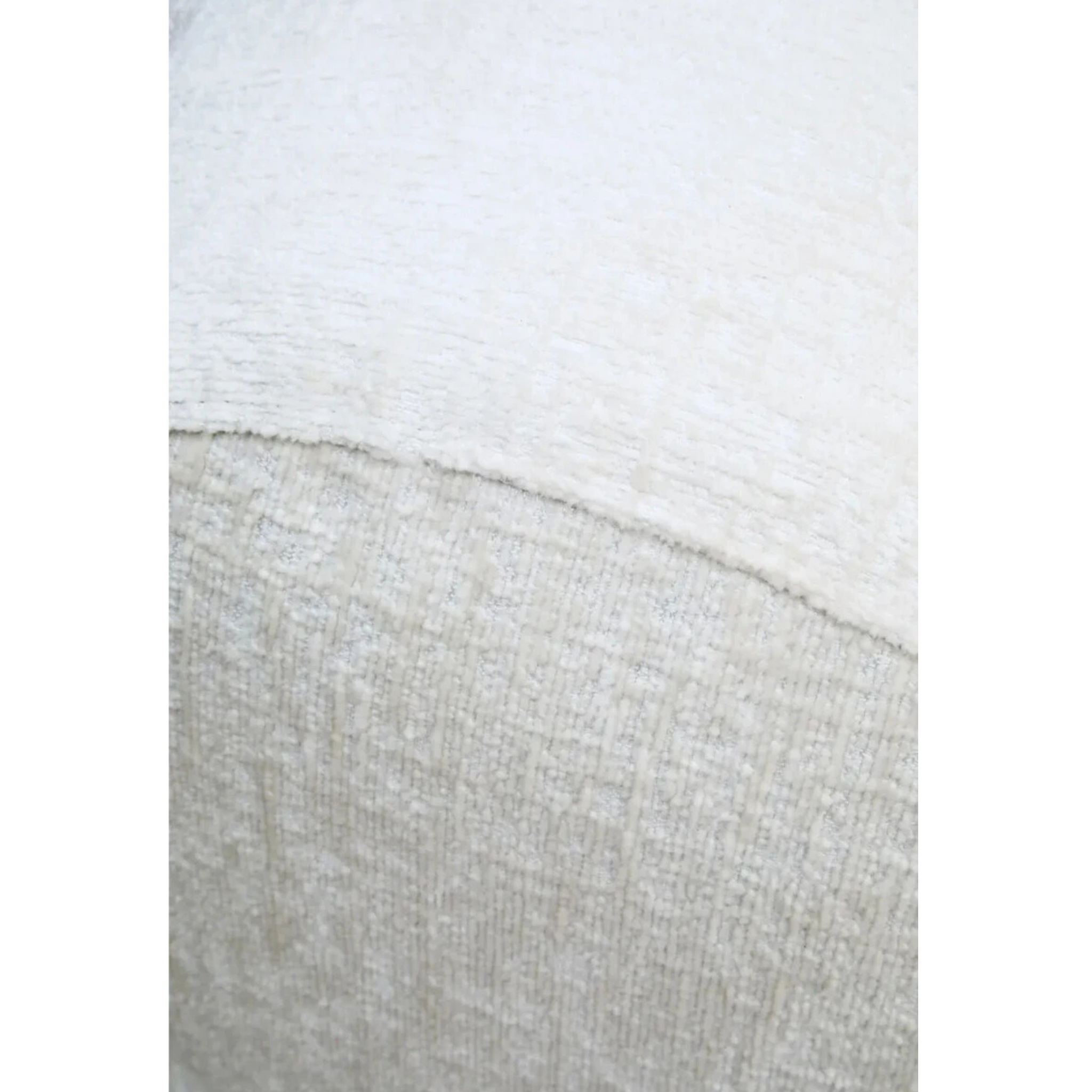 Close-up of Éveline cream sofa textured fabric upholstery and curved seam detail against a plain white background.