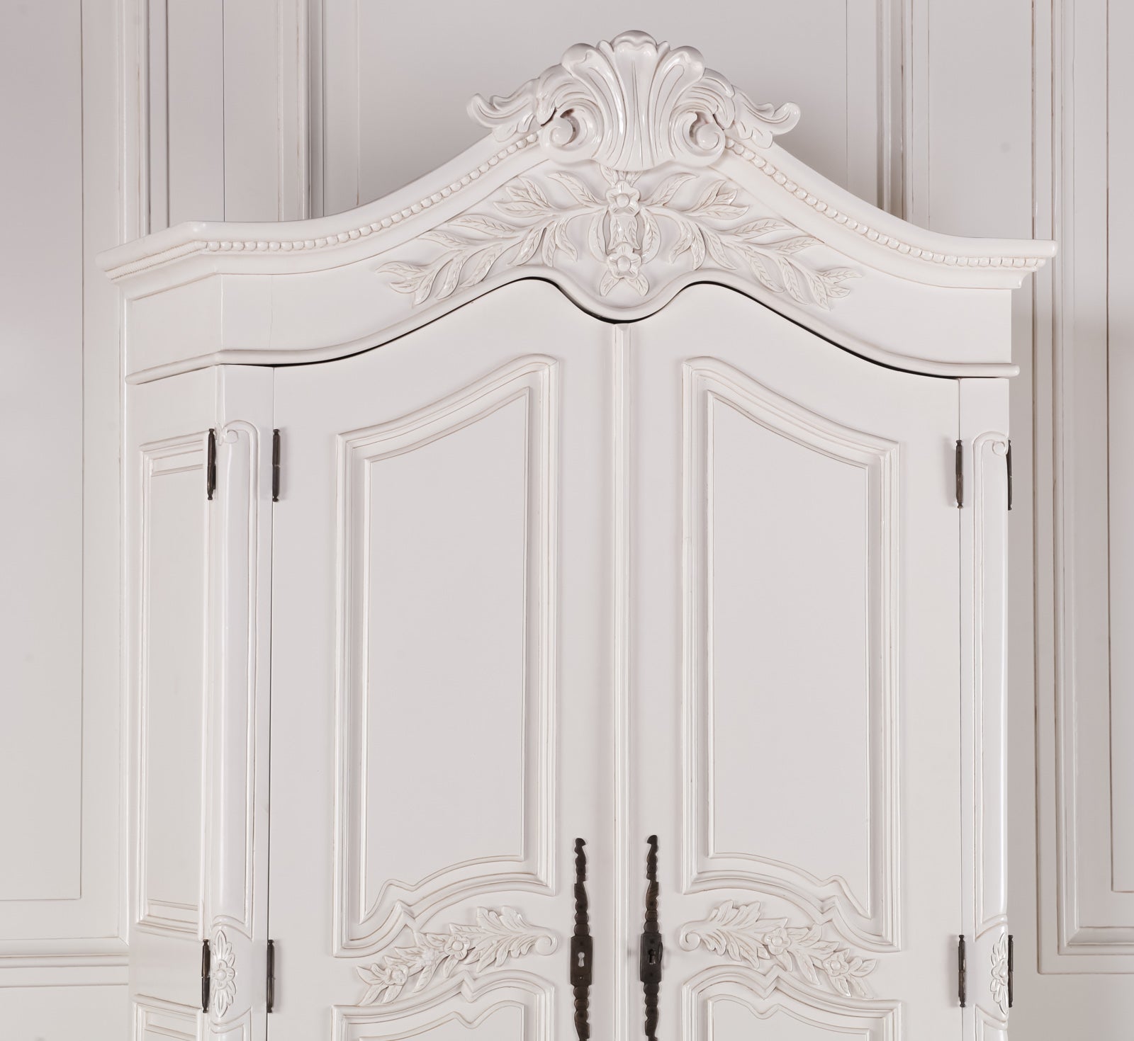 Upper section of the Geneviève Hand-Carved French Chateau Double Door Armoire Wardrobe highlighting the sculpted crest, floral carvings, decorative cornice and timeless French Chateau craftsmanship.