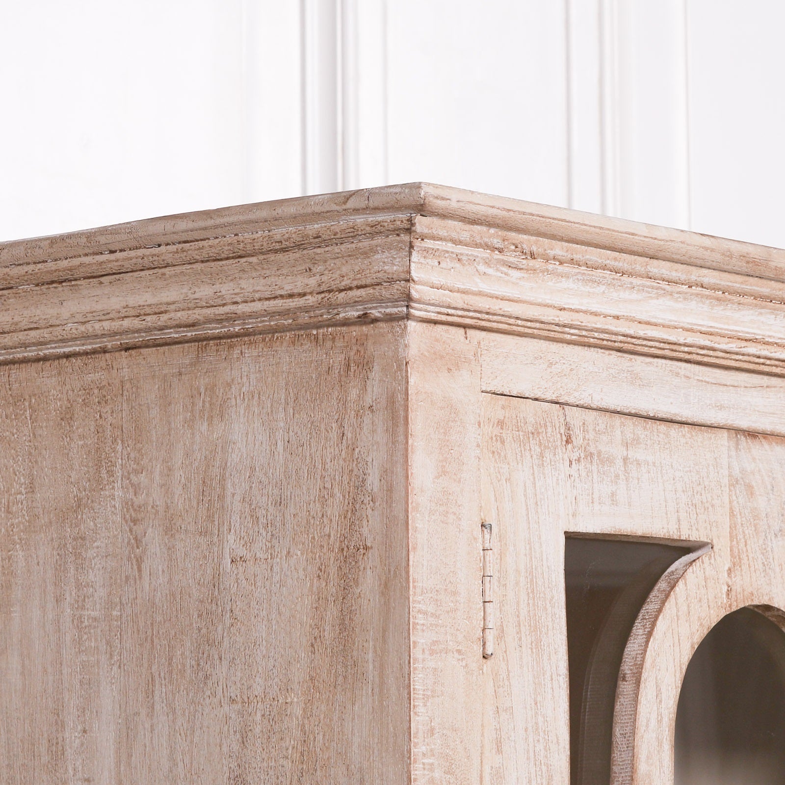 Close-up of the Henri Rustic Mango Wood Display Cabinet highlighting the handcrafted corner construction, moulded top, weathered rustic finish and premium mango wood grain showcasing quality craftsmanship.