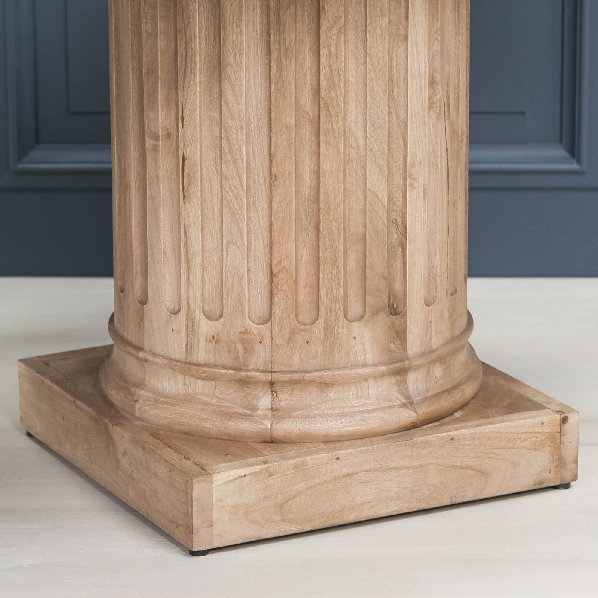 Detailed close-up of the fluted column pedestal base on the Henri 220cm Rustic Mango Wood Rectangular Column Dining Table, highlighting the natural mango wood grain, handcrafted craftsmanship, rustic finish and substantial square pedestal base.