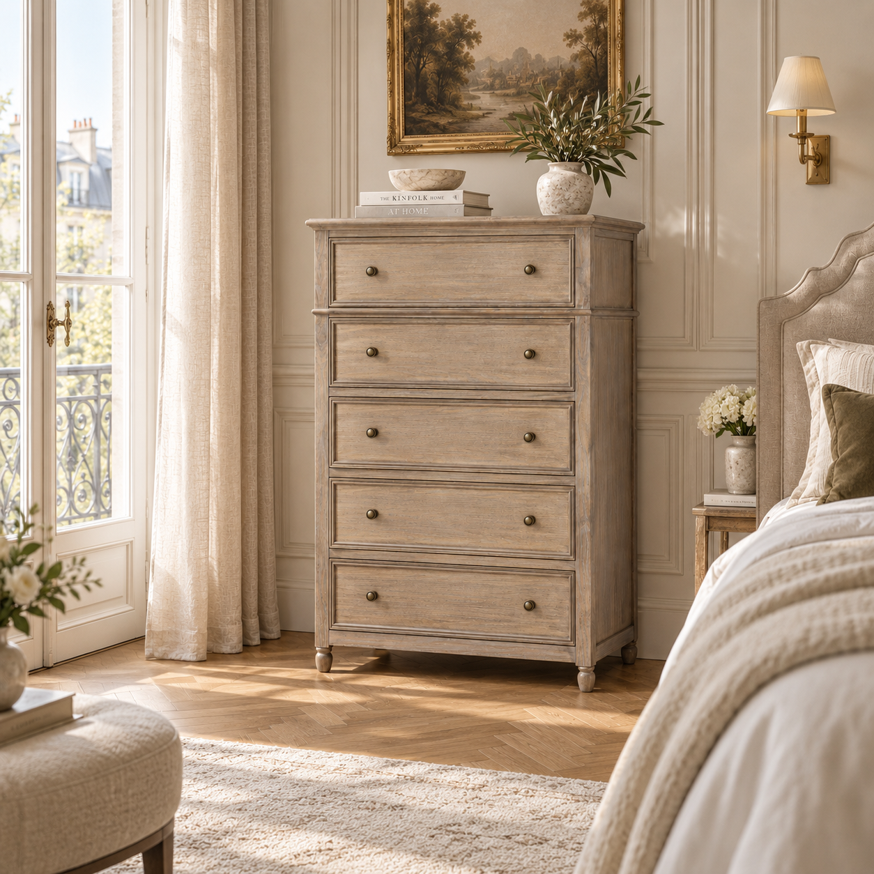 Laurent 128cm tall brown wood 5 drawer chest in an elegant sunlit bedroom beside a bed and French windows.