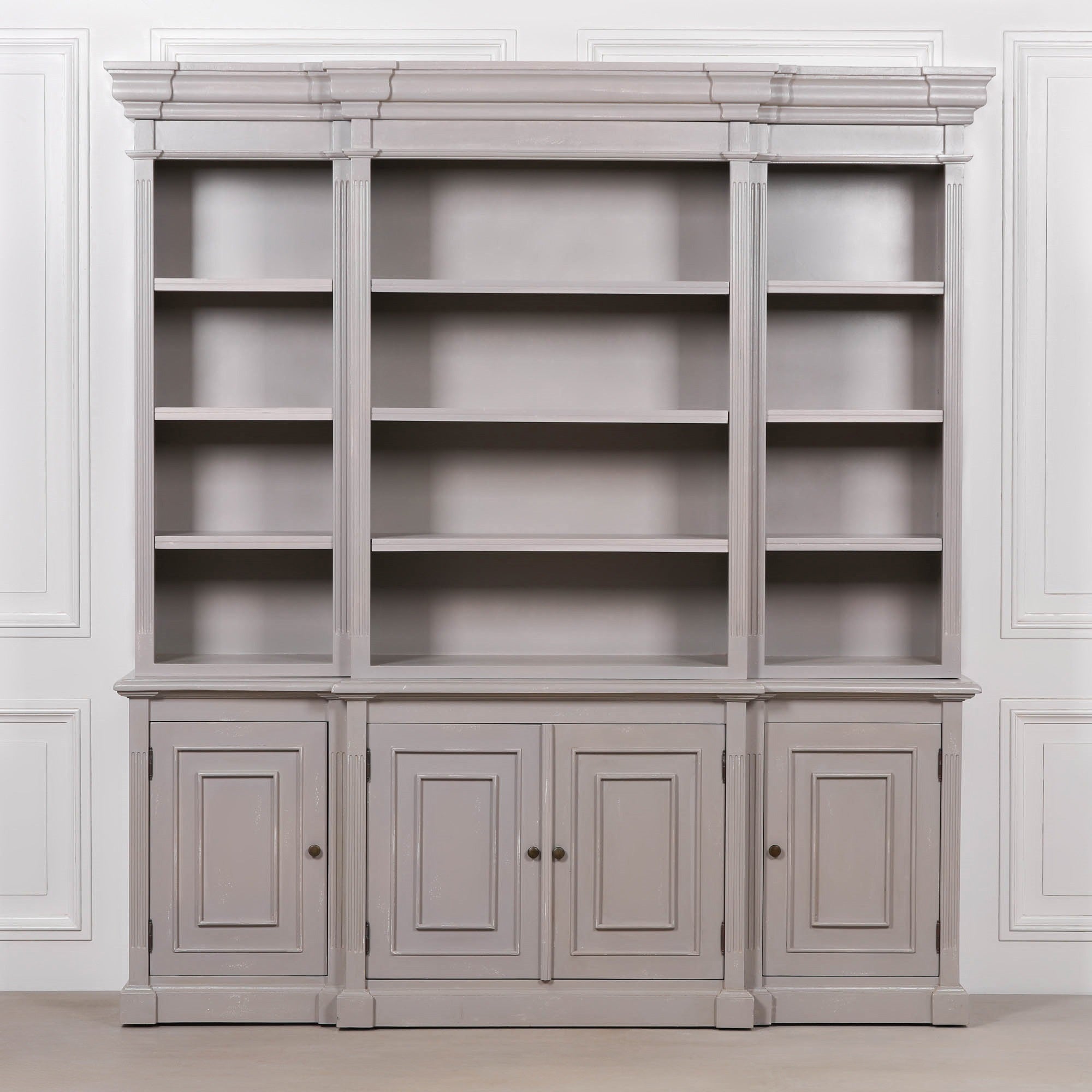 Laurent 200cm distressed mahogany bookcase with adjustable shelves and 4 door storage against a white panelled wall