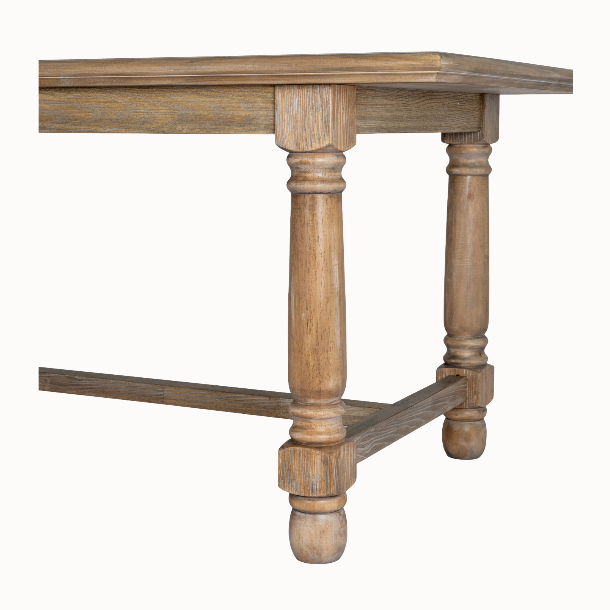 Close-up of Laurent brown wood dining table with turned legs and stretcher base against a white background.