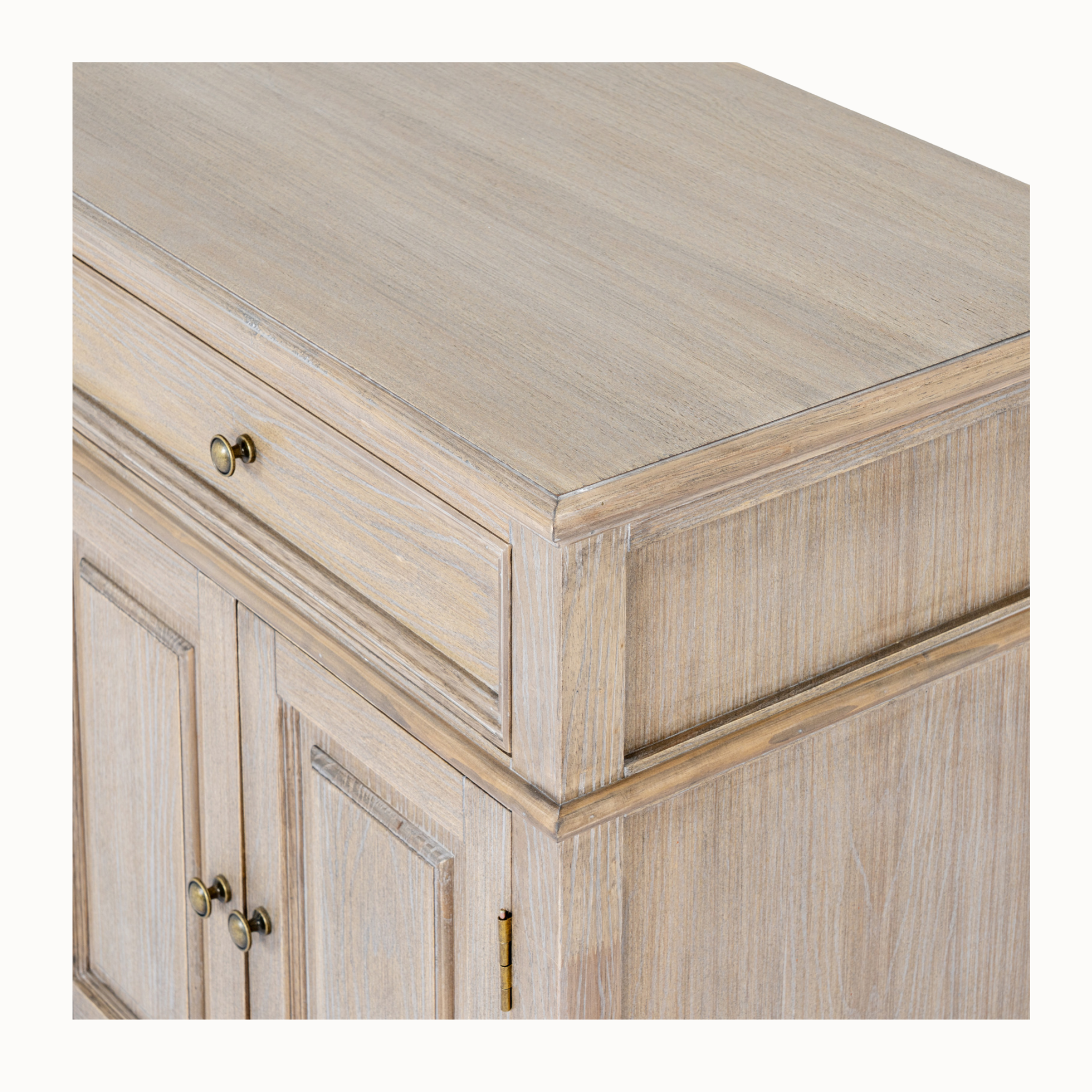 Close-up of Laurent brown wood sideboard showing the wood grain top, drawer and panelled doors on a white background.