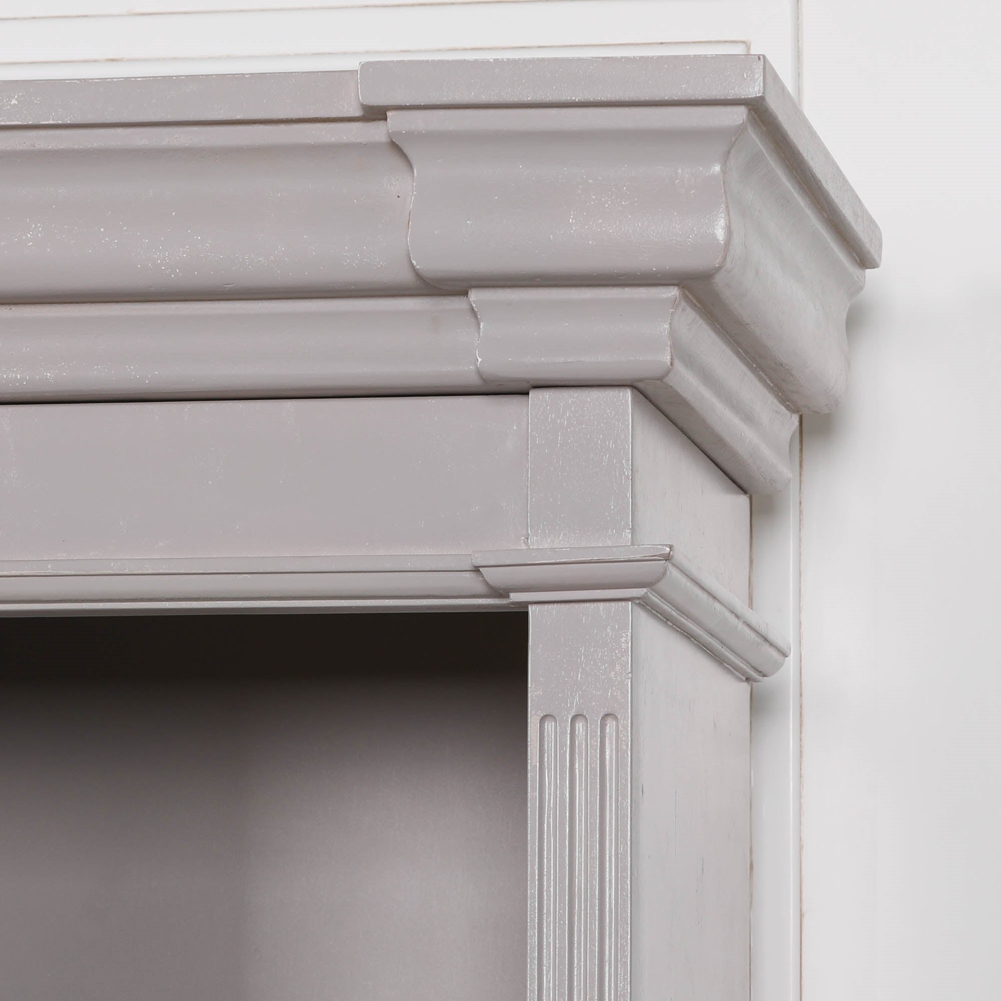 Close-up of Laurent distressed mahogany bookcase with cornice moulding and fluted column against a white background