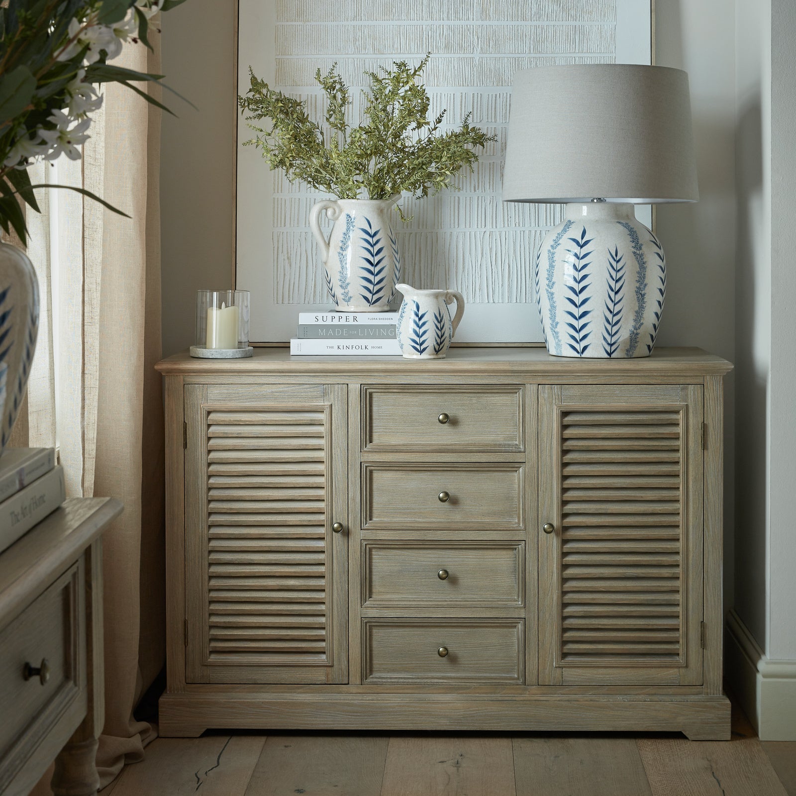 Laurent Large Wood Dresser Cabinet with 2 Doors & 4 Drawers styled in an elegant living room, featuring louvred cupboard doors, four spacious drawers, a natural wood finish and decorative accessories for stylish living room, dining room or hallway storage.