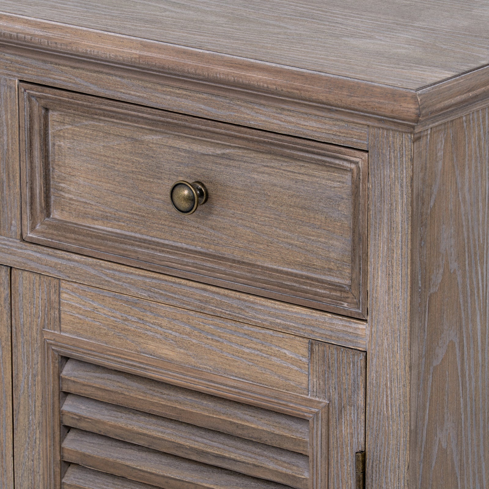 Detailed close-up of the Laurent Wood Storage Chest with 2 Doors & 2 Drawers showcasing the framed drawer front, natural wood grain, antique brass knob, moulded top edge and handcrafted rustic finish.