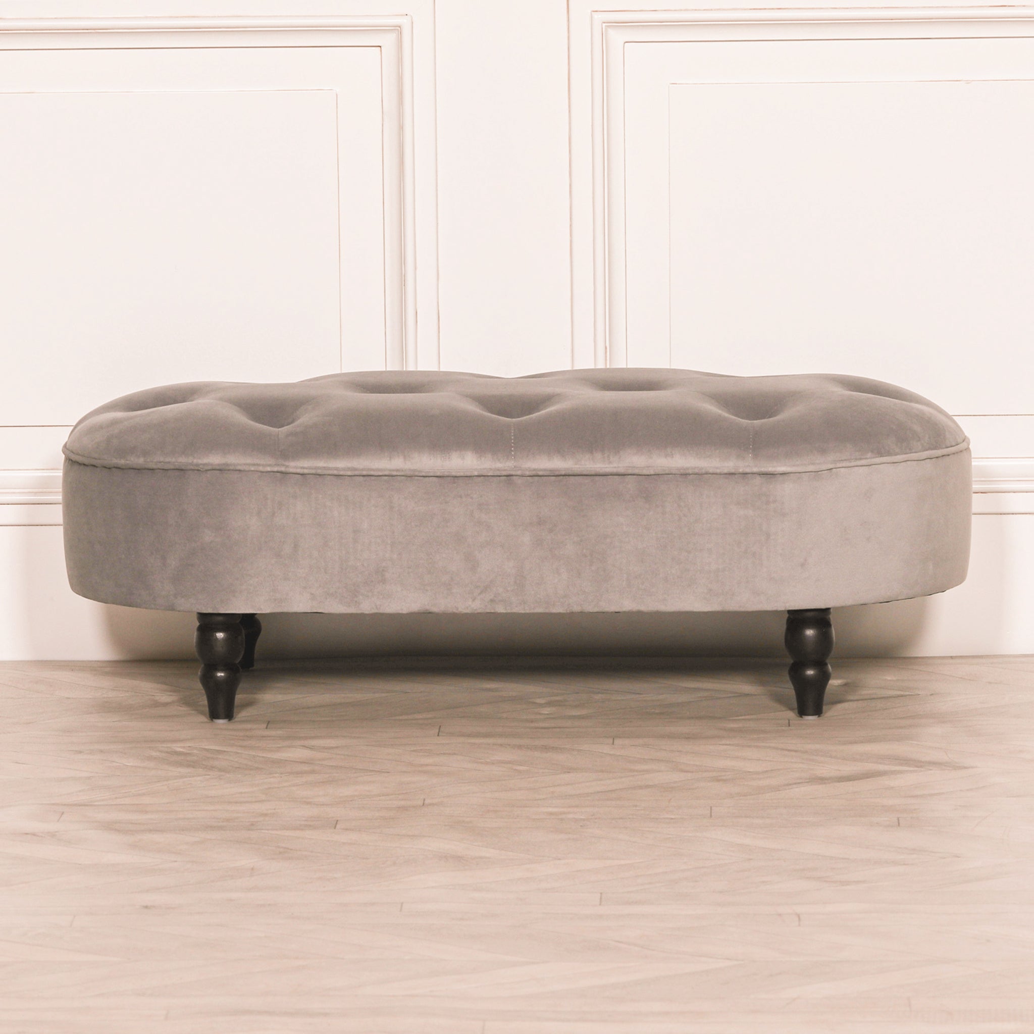 Front view of the Lucien Grey Velvet Upholstered Bedroom Bench with Black Legs highlighting the luxurious grey velvet upholstery, deep tufted seat and elegant bedroom bench design.