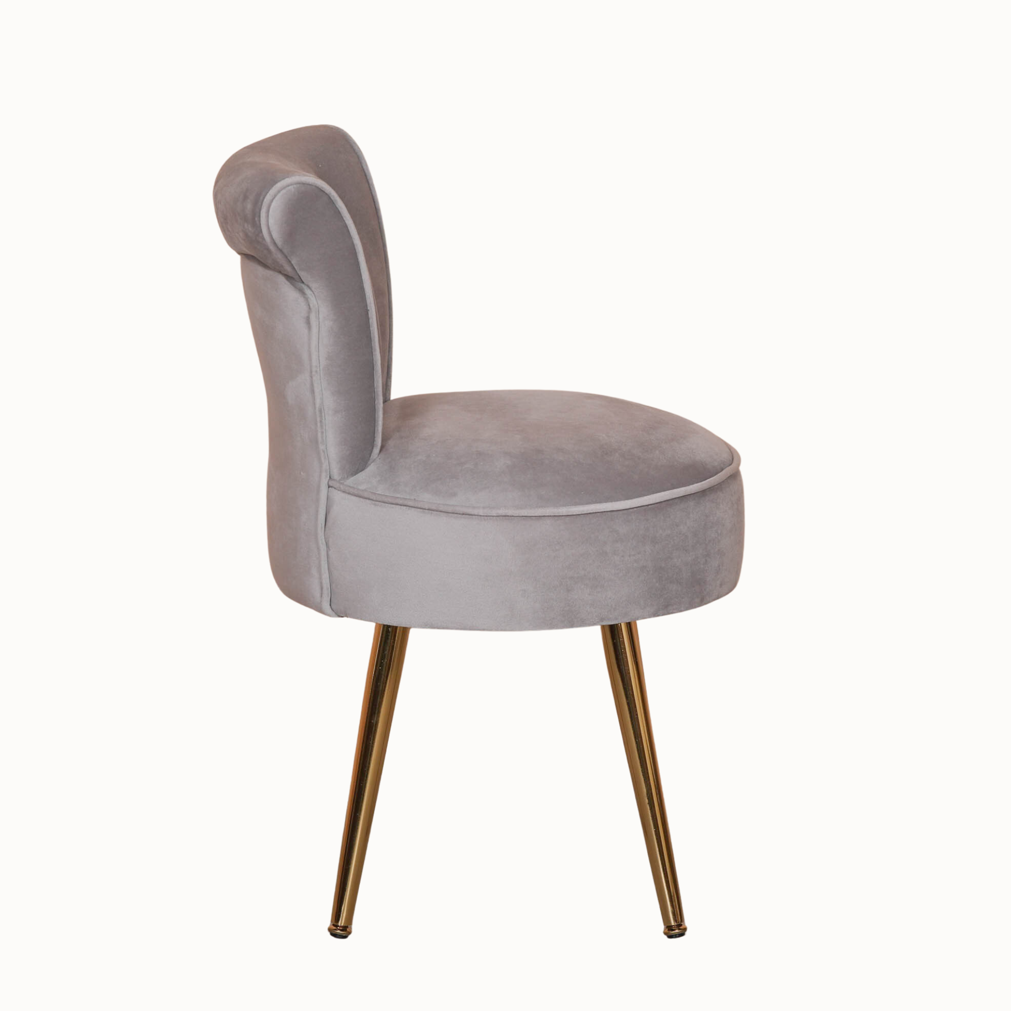 Side view of light grey velvet accent chair with curved wingback and gold legs against a plain white background.