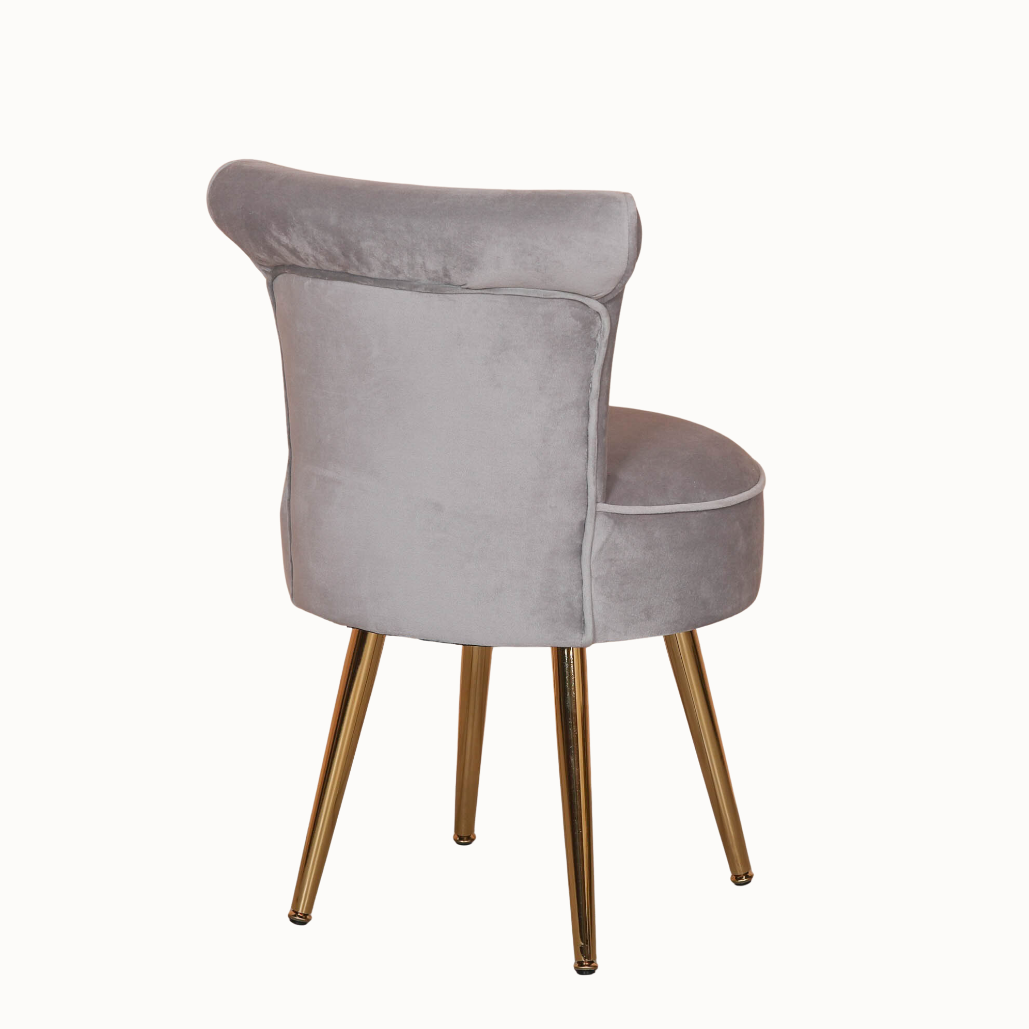 Rear view of light grey velvet bedroom chair with curved back and gold legs against a plain white background.