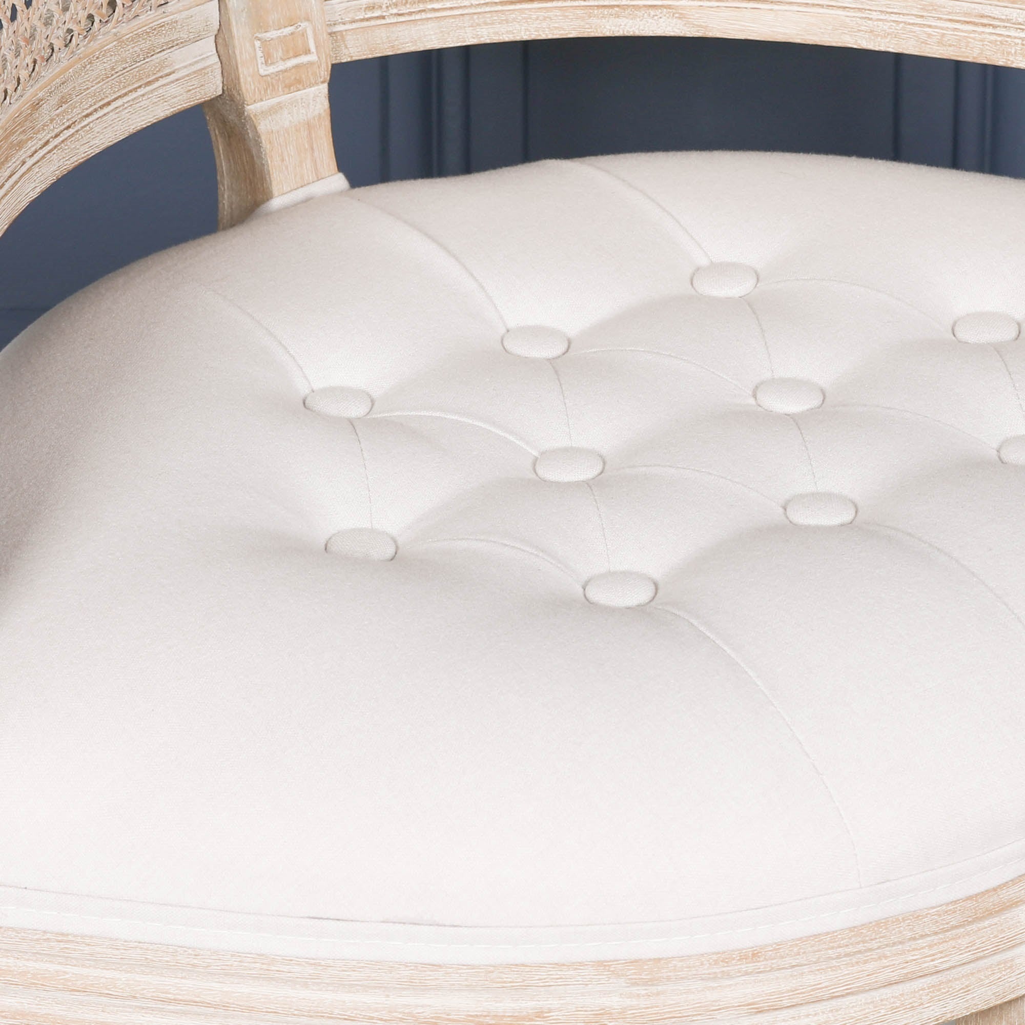 Close-up of the button-tufted natural linen upholstered seat on the Lucienne Louis corner chair with elegant French Louis styling.