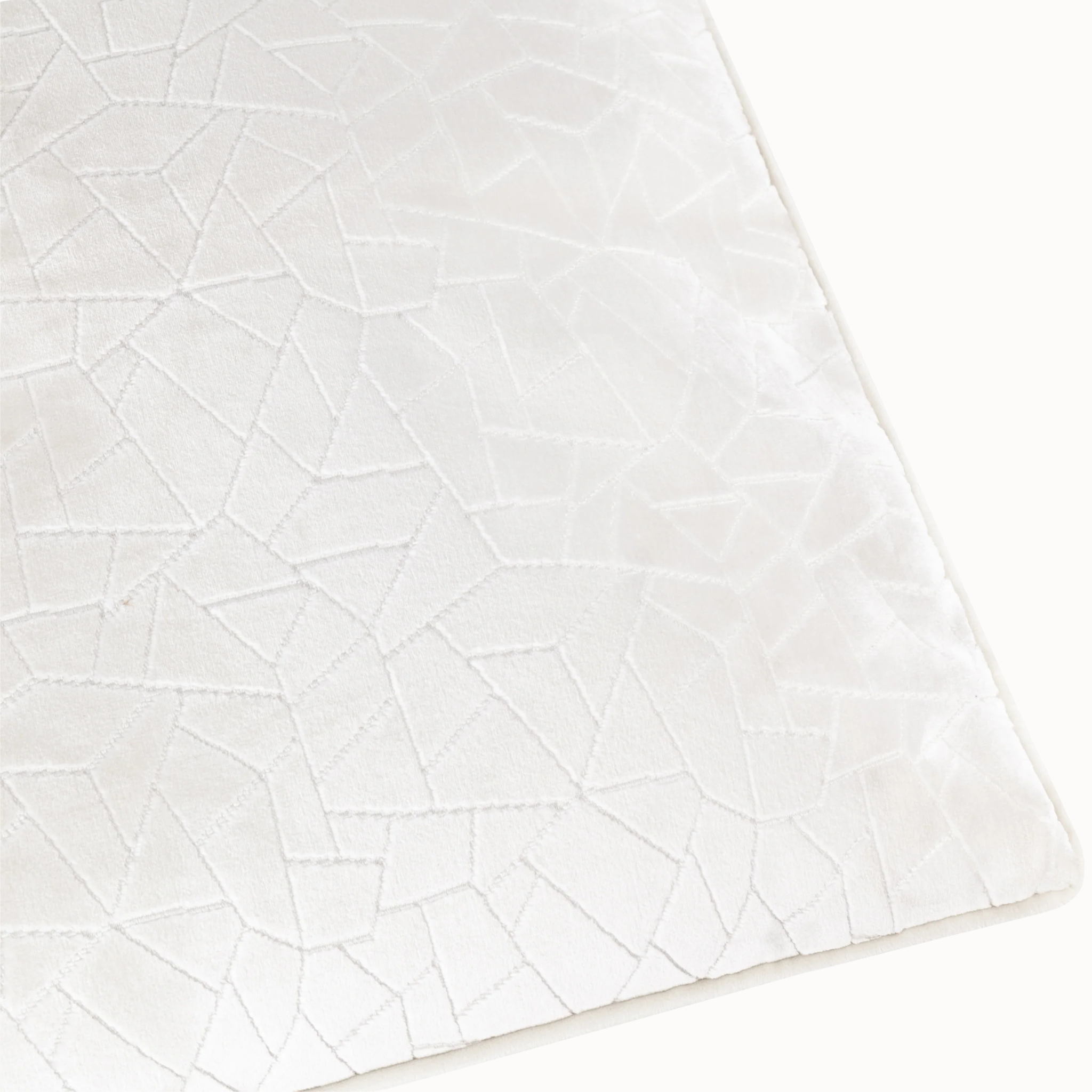 Close-up of Maëva milk cream cut velvet cushion showing geometric raised texture on a white background.