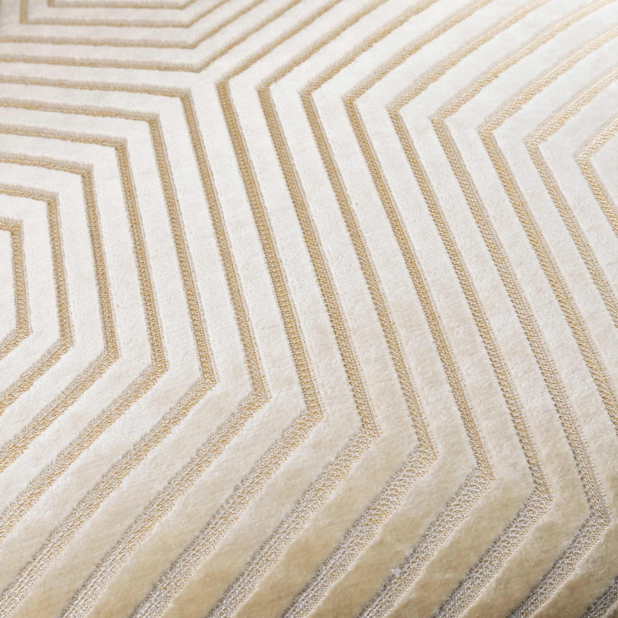 Close-up of Maëva ivory cut velvet cushion showing raised geometric chevron texture on a white background.