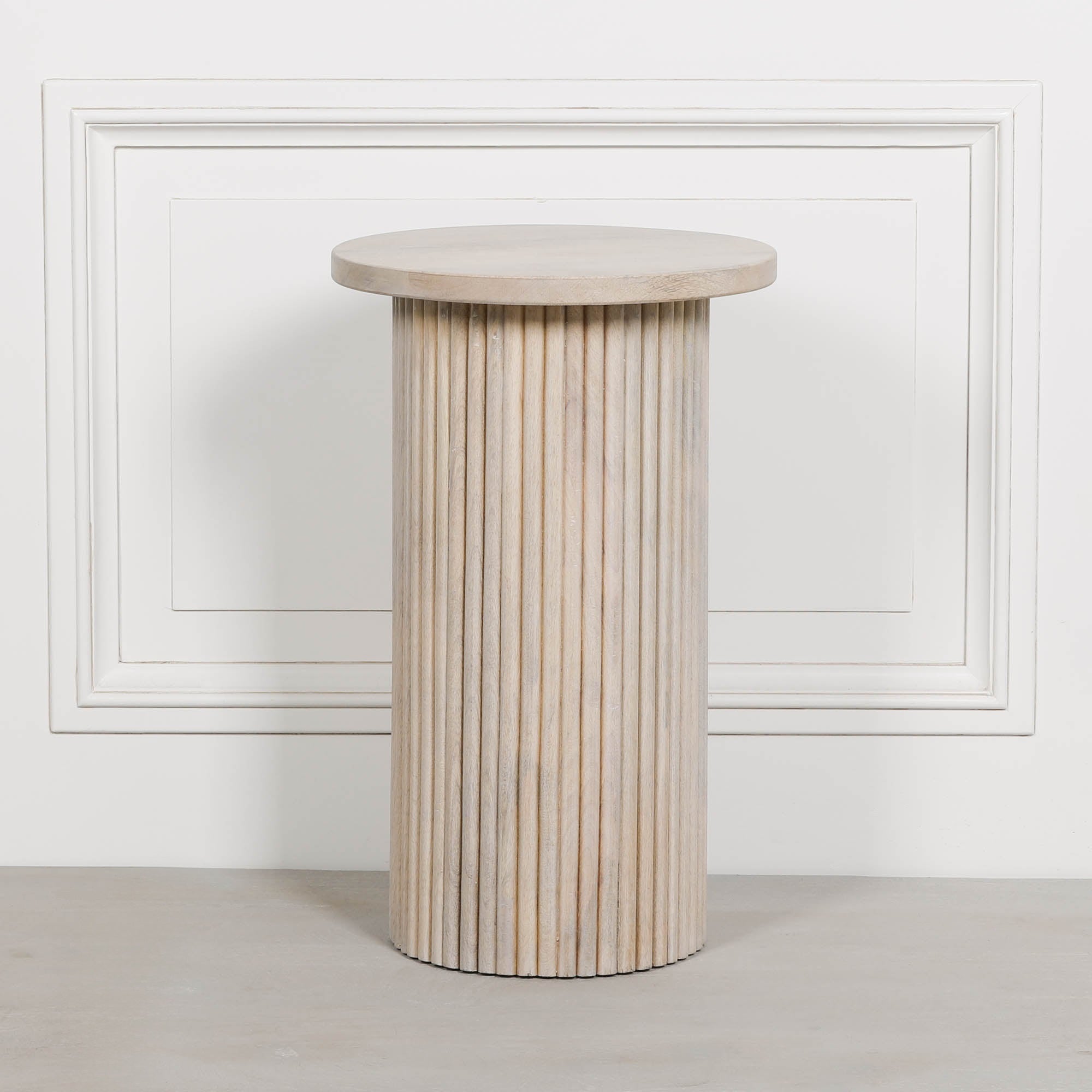 Front view of the Margaux ribbed round side table in washed mango wood featuring a round tabletop and sculptural fluted cylindrical base, creating a timeless wooden side table for living rooms, bedrooms and hallways.