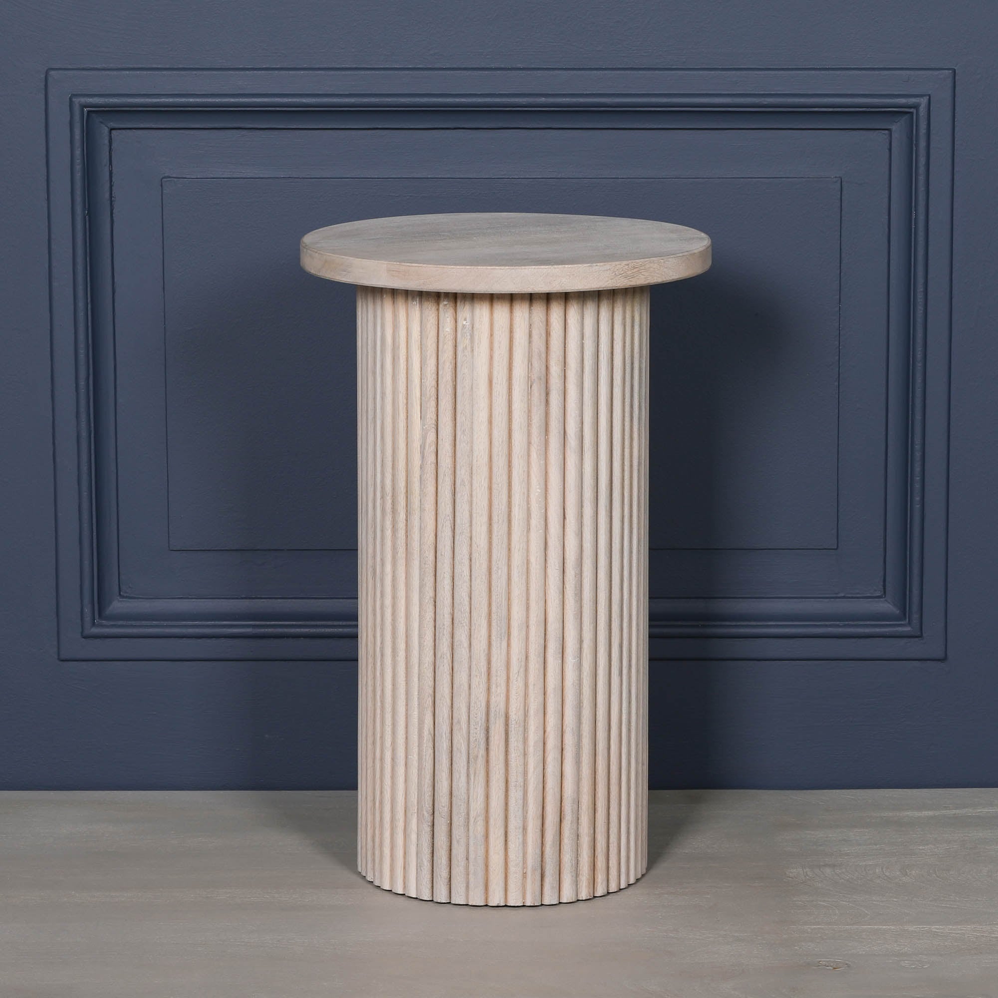 Full product view of the Margaux ribbed round side table in washed mango wood featuring a minimalist round tabletop and sculptural fluted cylindrical base, perfect as a wooden side table, bedside table or decorative accent table.