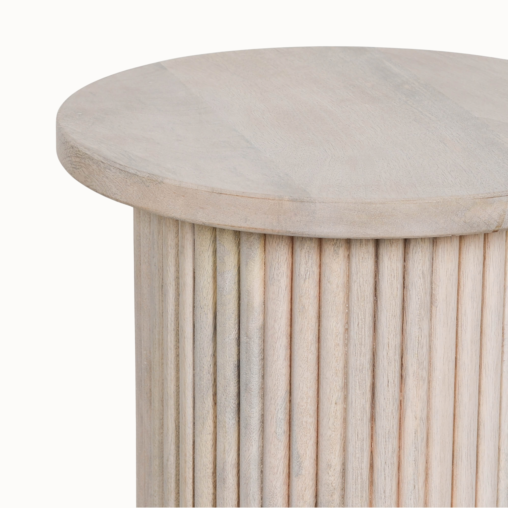 Close-up of Margaux round side table in washed mango wood showing smooth top and ribbed base on a white background.