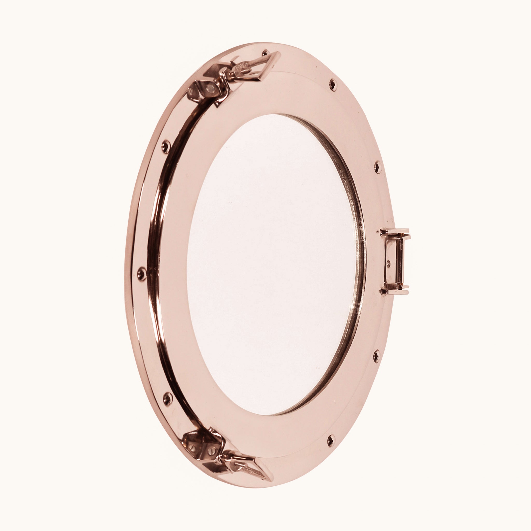 Marin Extra-Large Porthole Round Accent Wall Mirror with a highly polished aluminium frame, circular mirrored centre, exposed rivet details, hinge and nautical-style locking clasps.