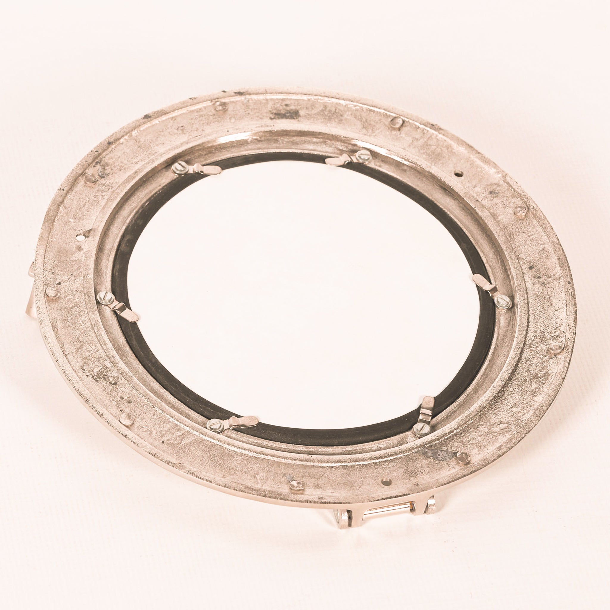 Rear view of the Marin Extra-Large Porthole Round Accent Wall Mirror showing the circular aluminium frame, mirror backing, retaining clips, metal fixings and porthole hardware.