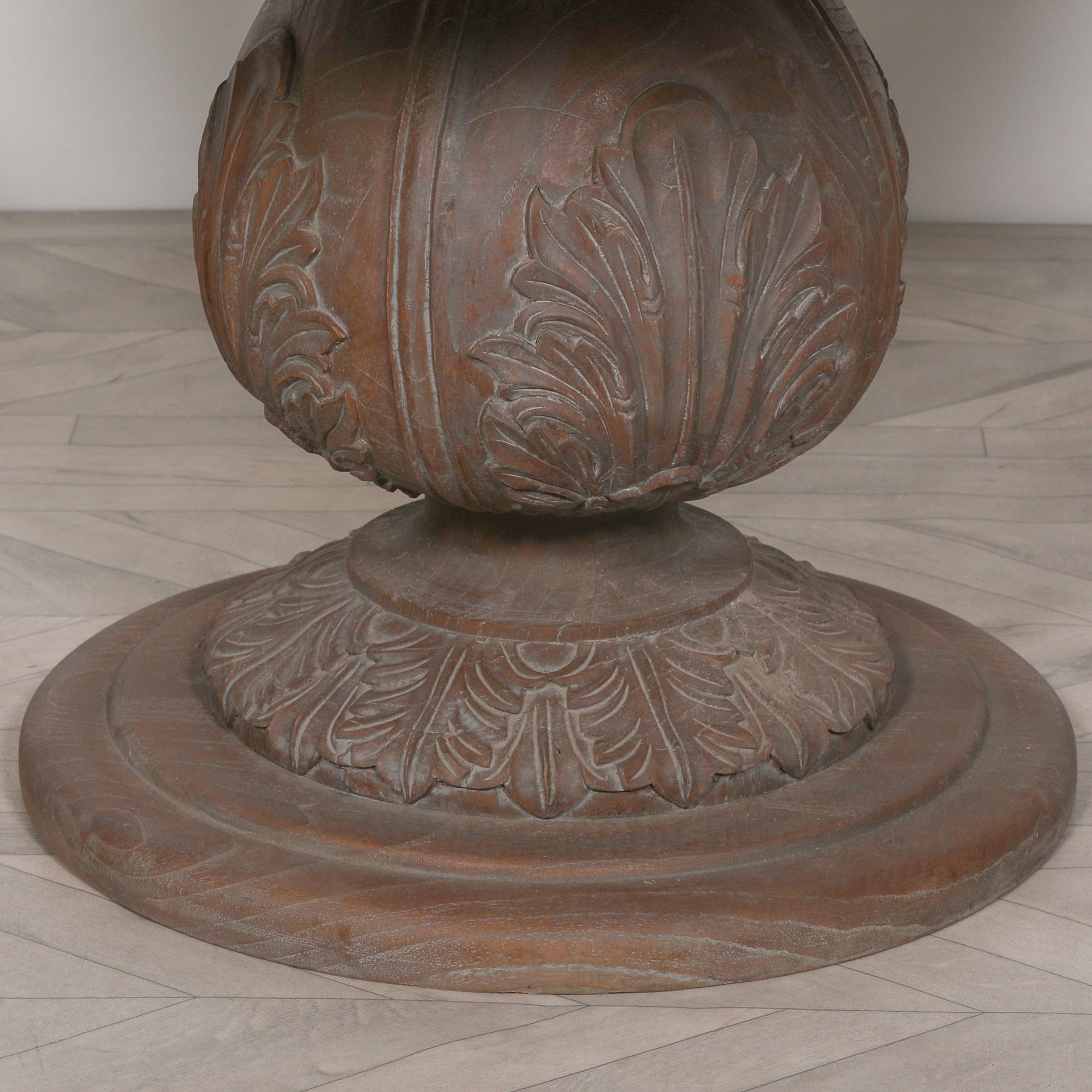 Detailed view of the carved reclaimed cedar wood pedestal base on the Mathis round dining table.