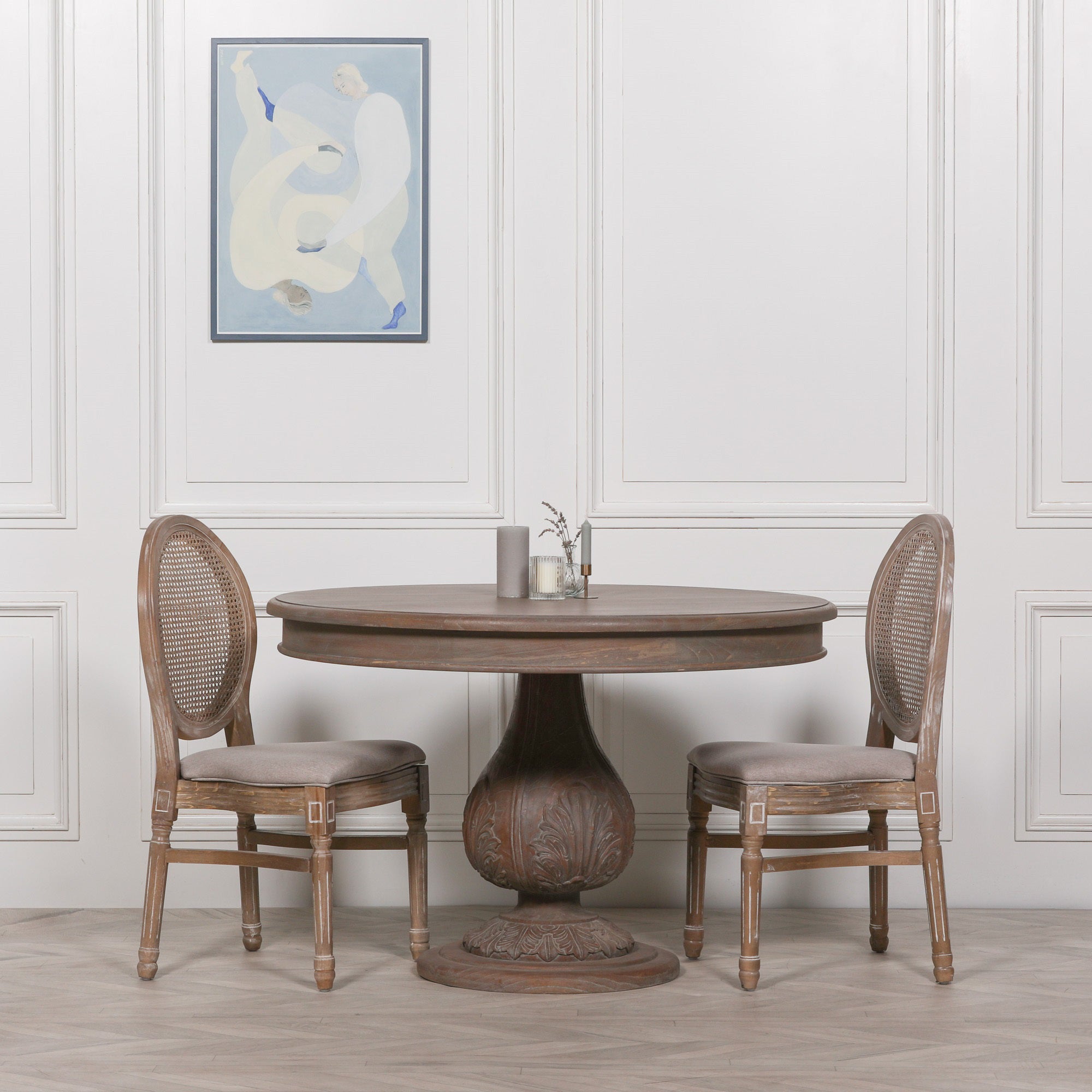 Mathis round pedestal dining table 120cm in reclaimed cedar wood styled with Louis dining chairs in a luxury dining room.