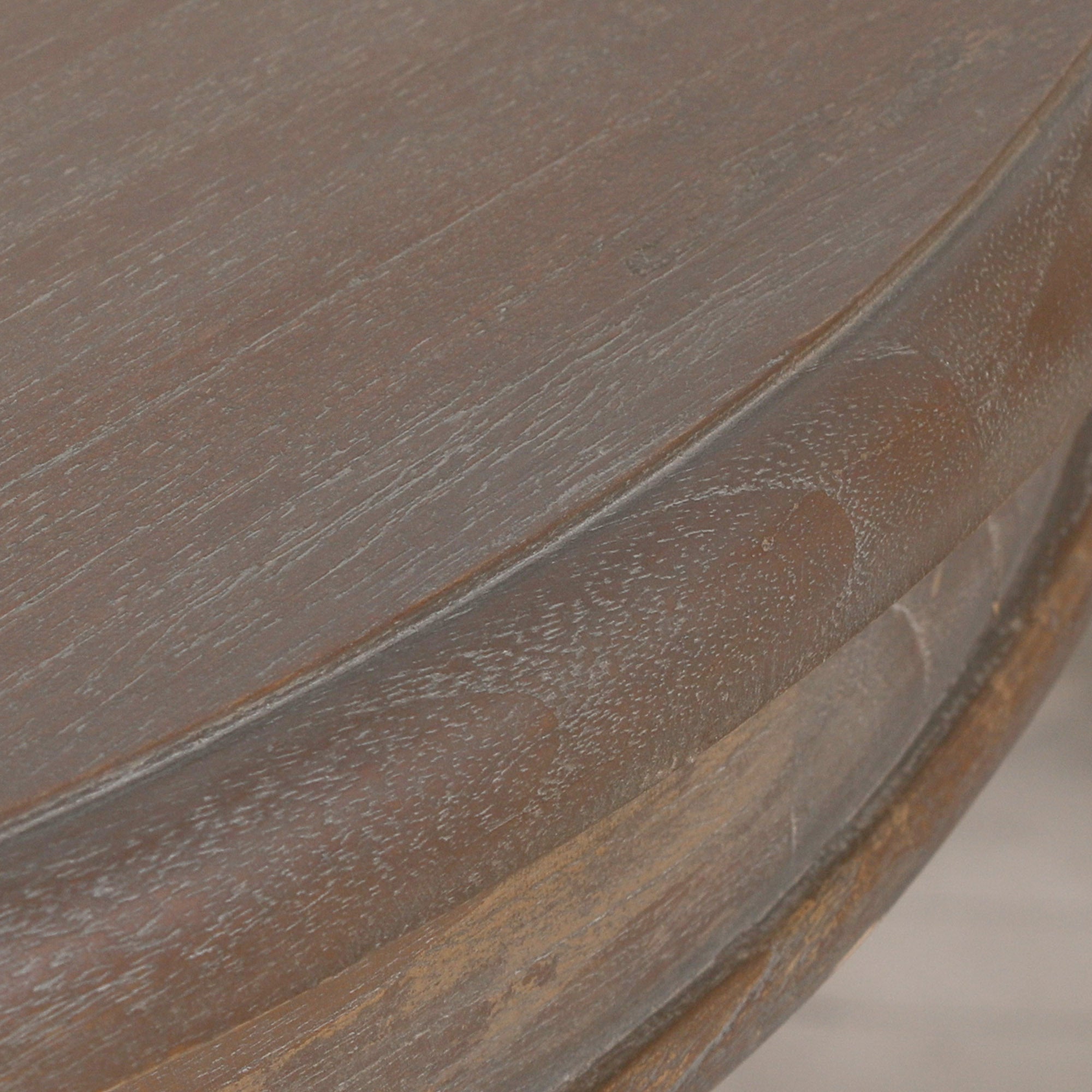 Detail of the reclaimed cedar wood tabletop showing the natural grain and dark rustic finish of the Mathis dining table.