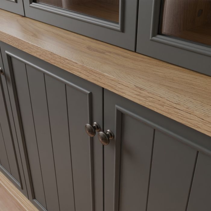Close-up of the Montclair grey and oak effect display cabinet showing the oak effect surface, panelled cupboard doors and traditional metal door handles.