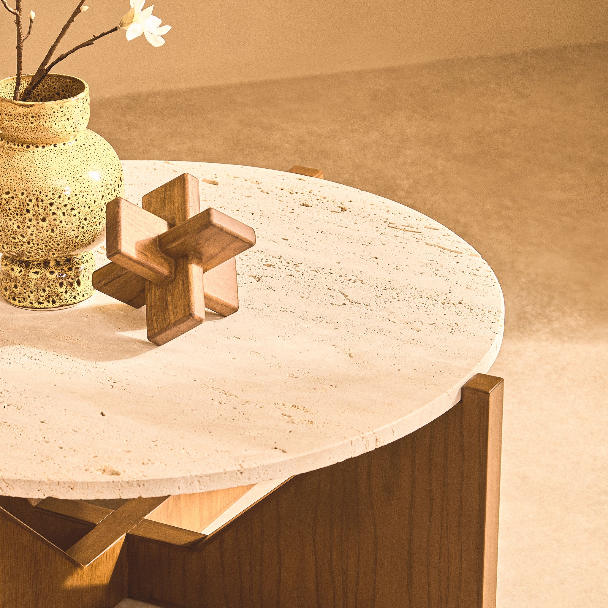 Noé brown acacia wood sculptural object styled beside a decorative vase on a round stone-topped side table in a warm neutral interior