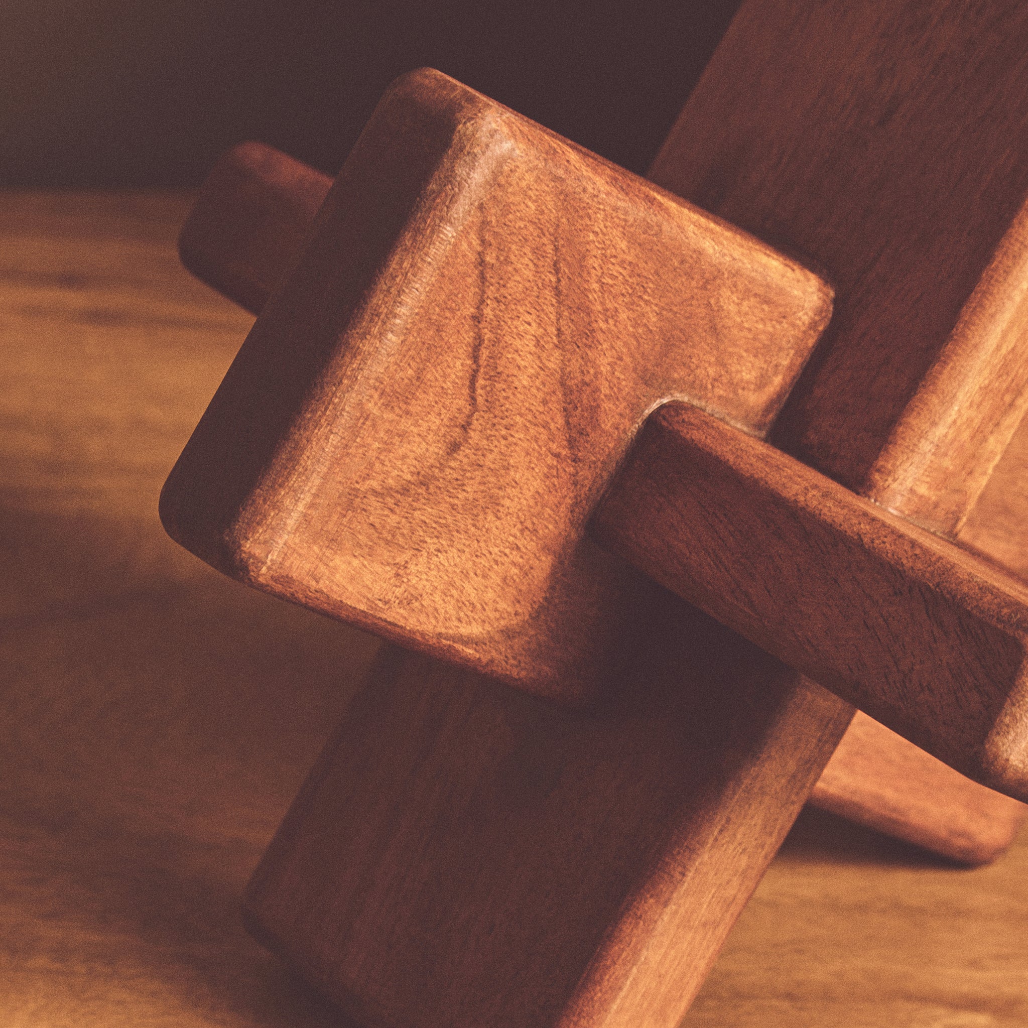 Detailed close-up of the Noé hand-carved acacia wood sculptural object highlighting the rich brown finish, natural grain and geometric construction