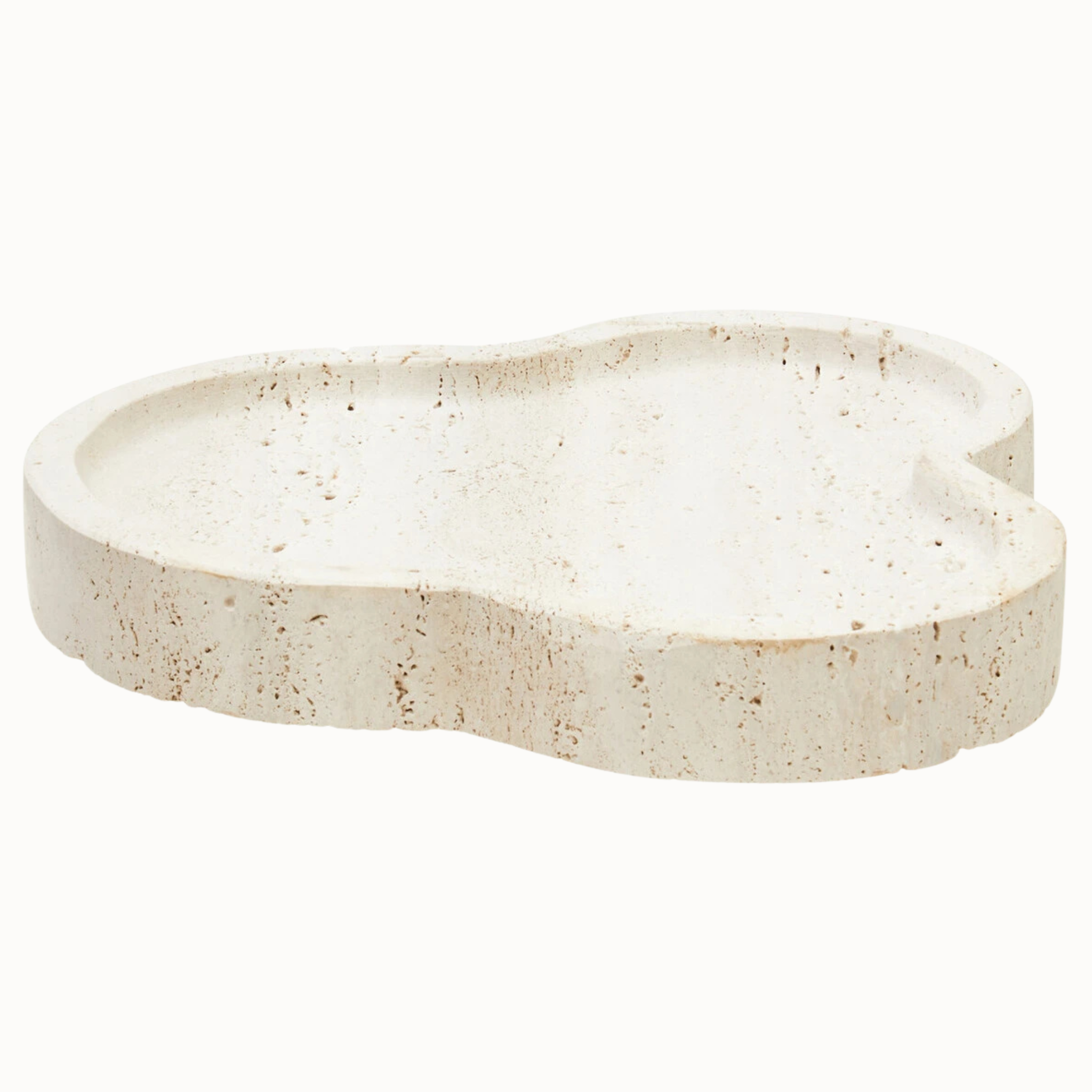 Noé irregular travertine stone tray with sculptural organic outline and warm beige porous finish on white.