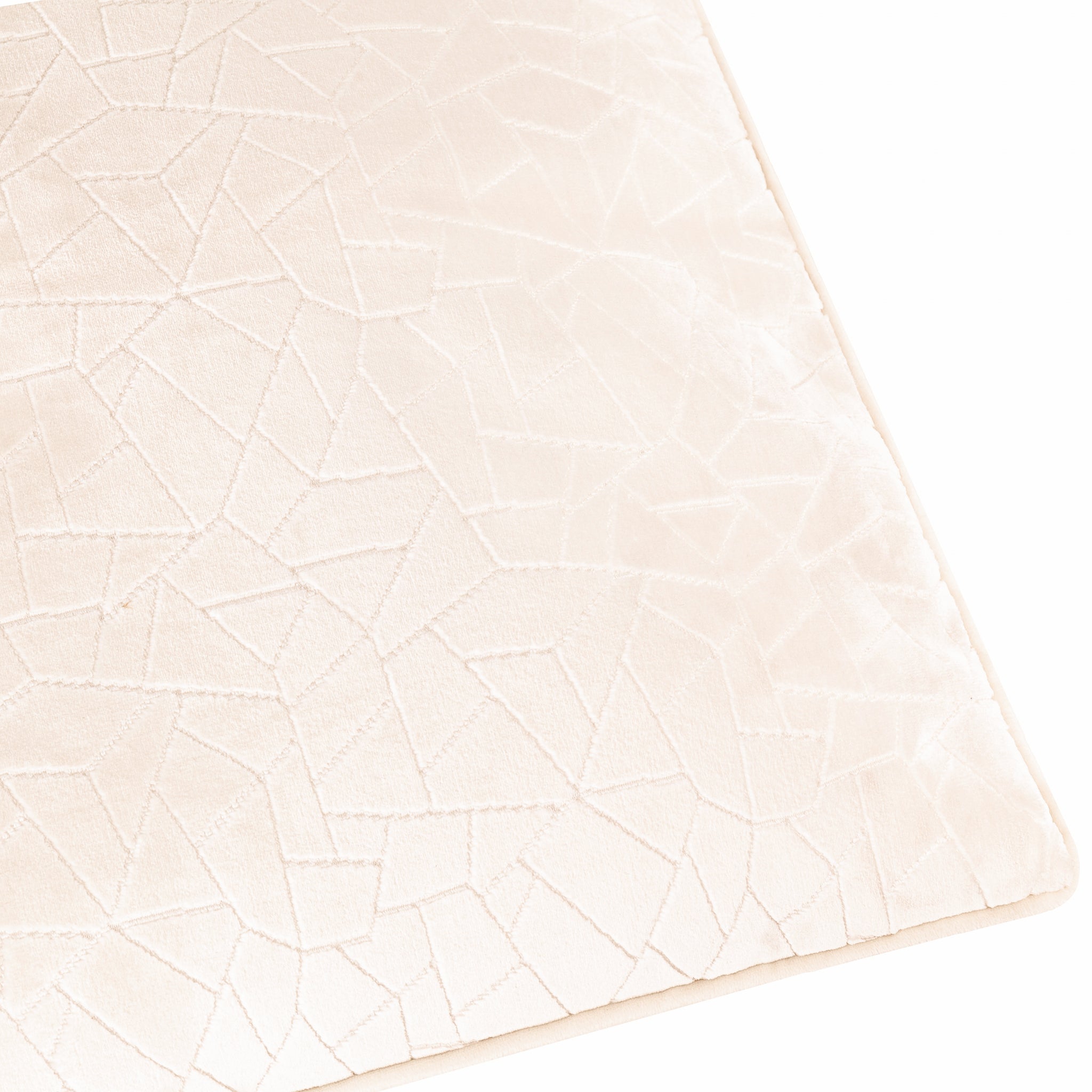 Close-up of the Noé Maëva cream cushion fabric, highlighting the intricate tonal geometric cut velvet pattern, soft textured surface and refined piped edge detailing.