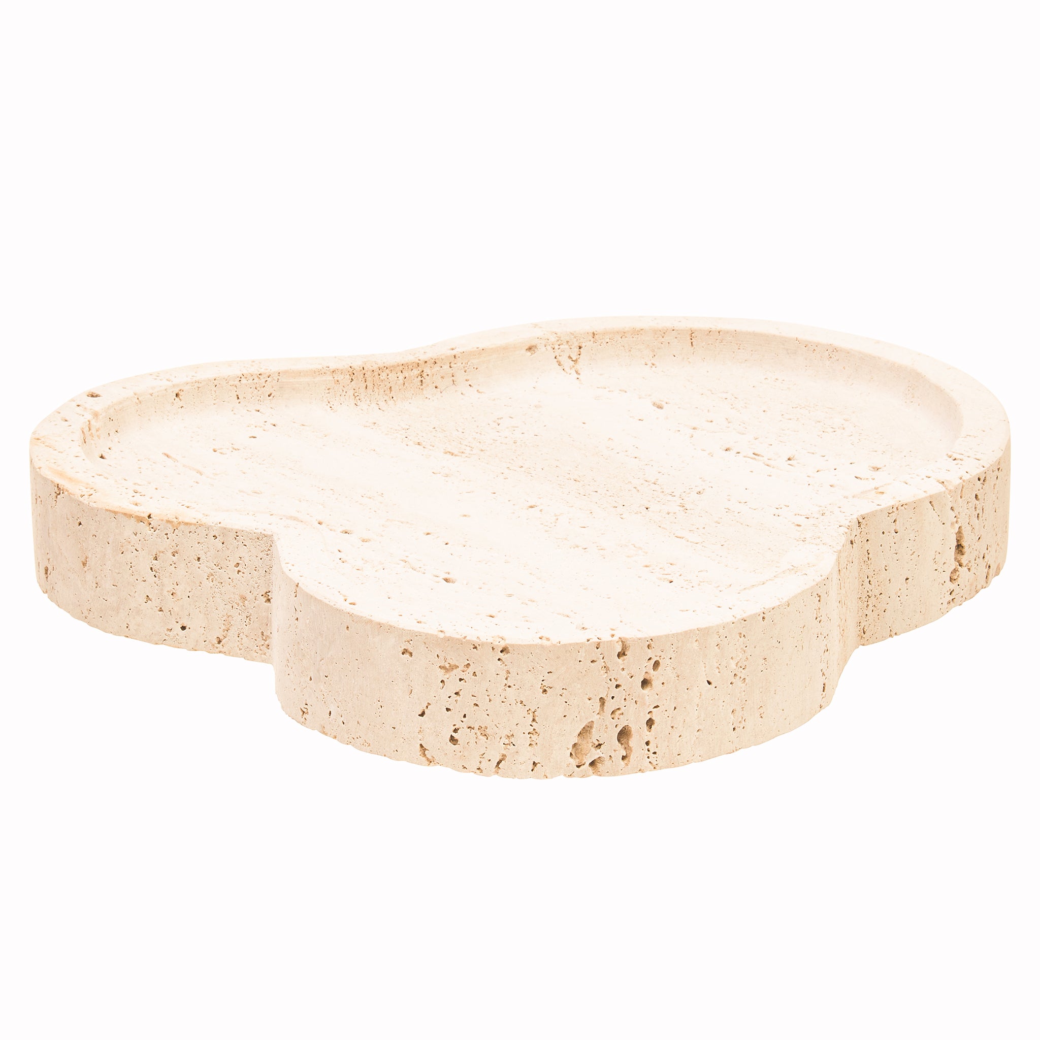 Front angled view of the Noé travertine decorative tray highlighting its distinctive irregular form, curved raised rim and porous natural stone character.