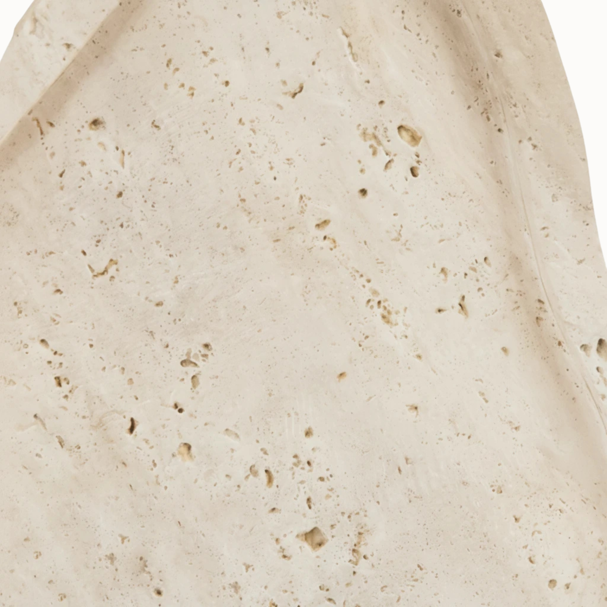 Close-up of Noé travertine tray showing natural beige stone pores, pits and tonal variation on white.