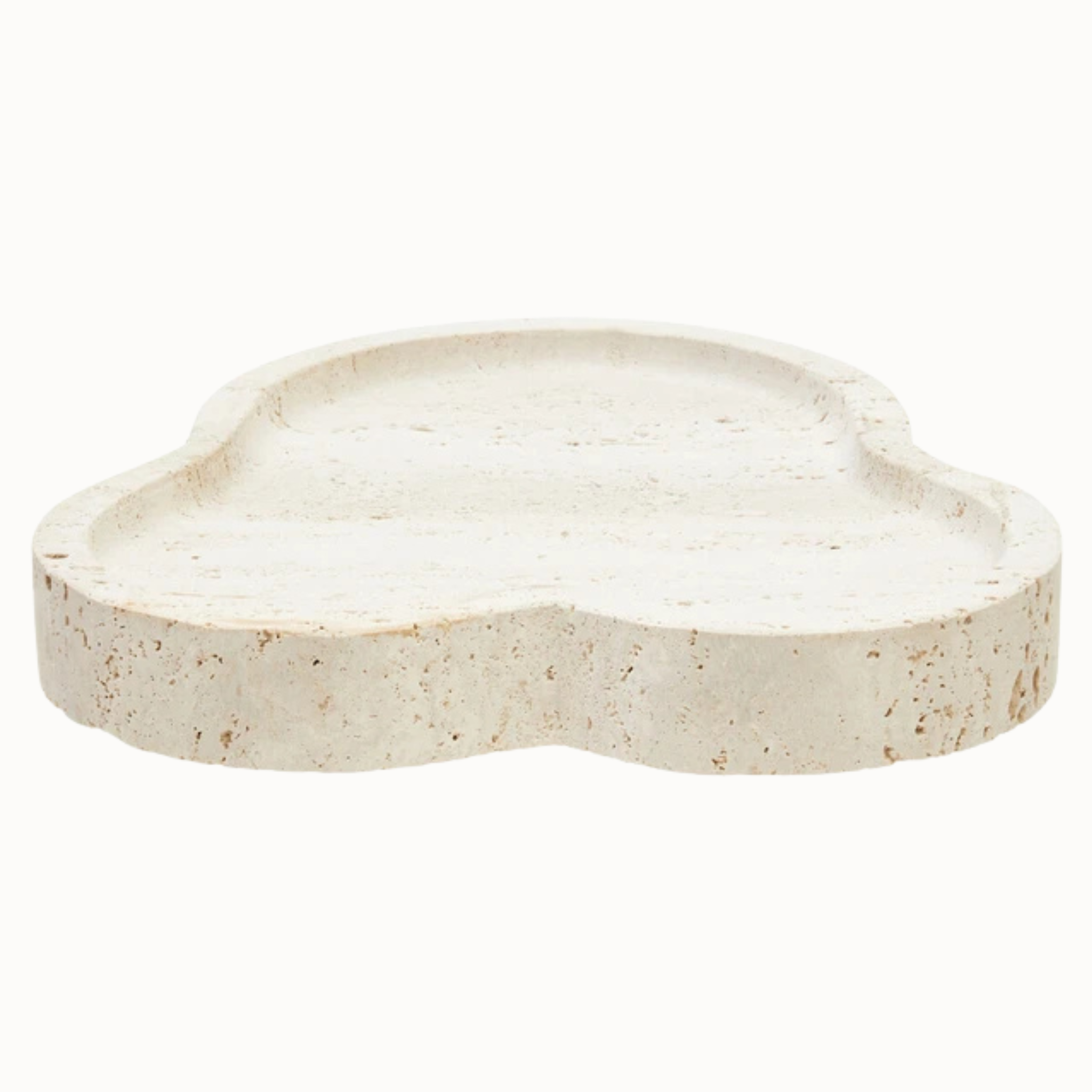 Front view of Noé irregular travertine tray with rounded organic form and porous beige stone on white.