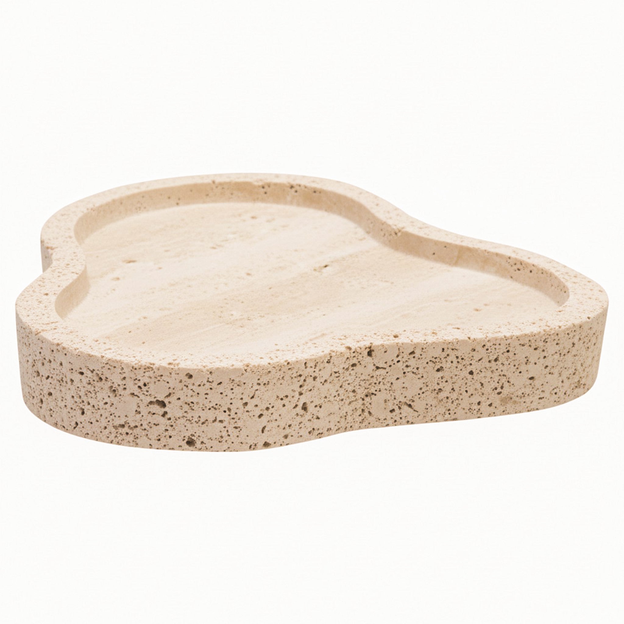 Front angled view of the Noé Travertine Tray featuring an irregular organic silhouette, raised border and naturally textured neutral stone surface.