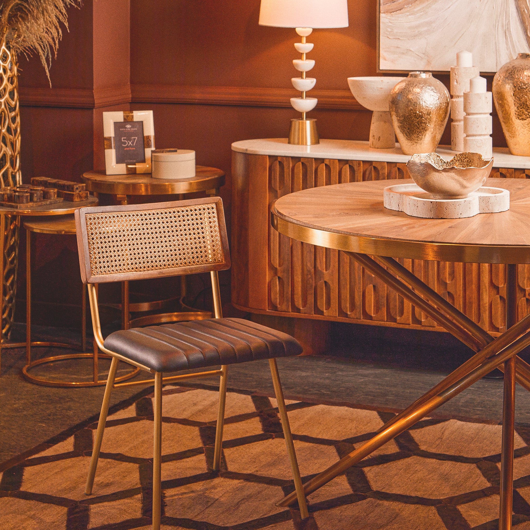 Noé Travertine Tray styled as a decorative centrepiece on a round wooden dining table within an elegant warm-toned interior.