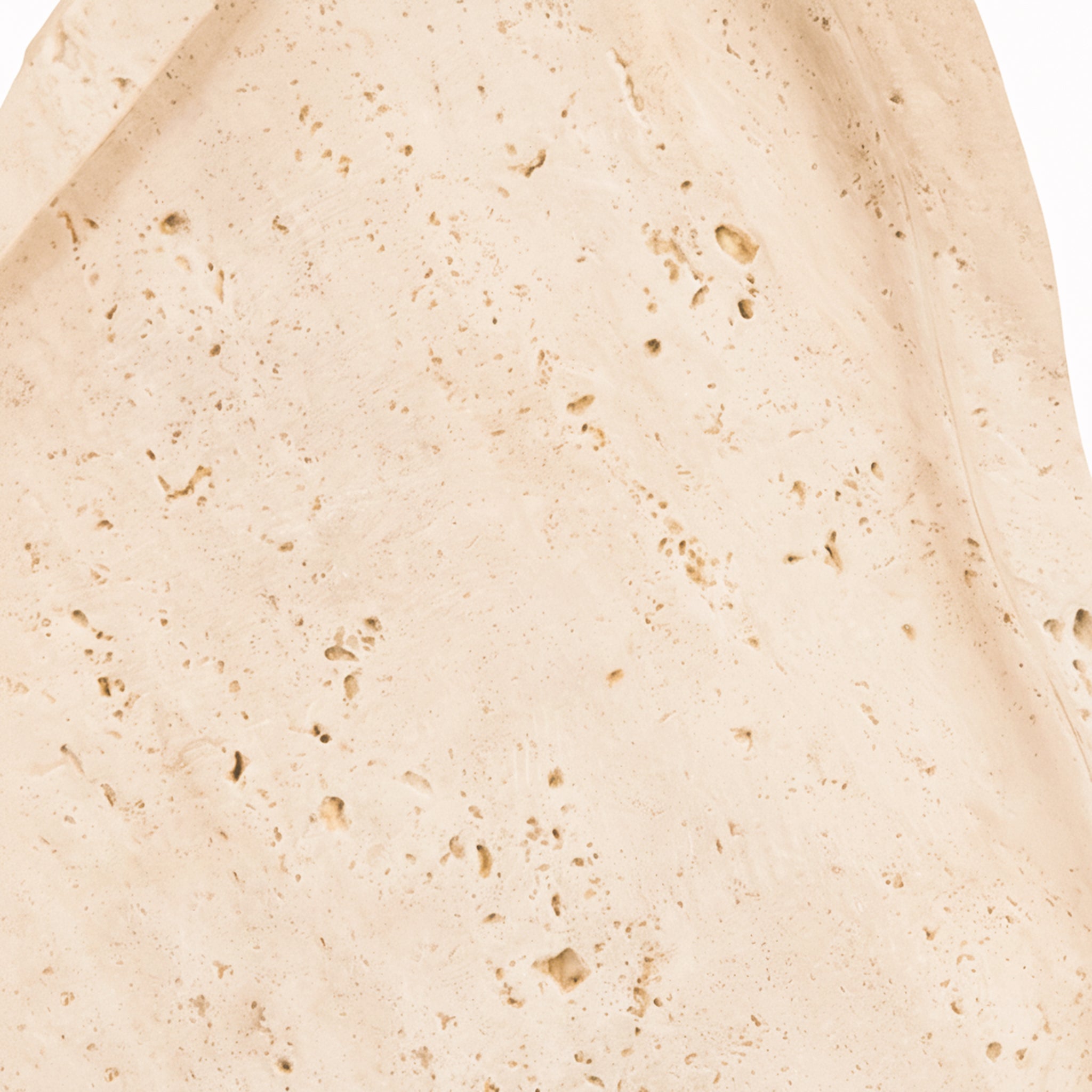 Extreme close-up of the Noé Travertine Tray revealing the authentic porous stone texture, subtle tonal variation and naturally occurring markings of travertine.