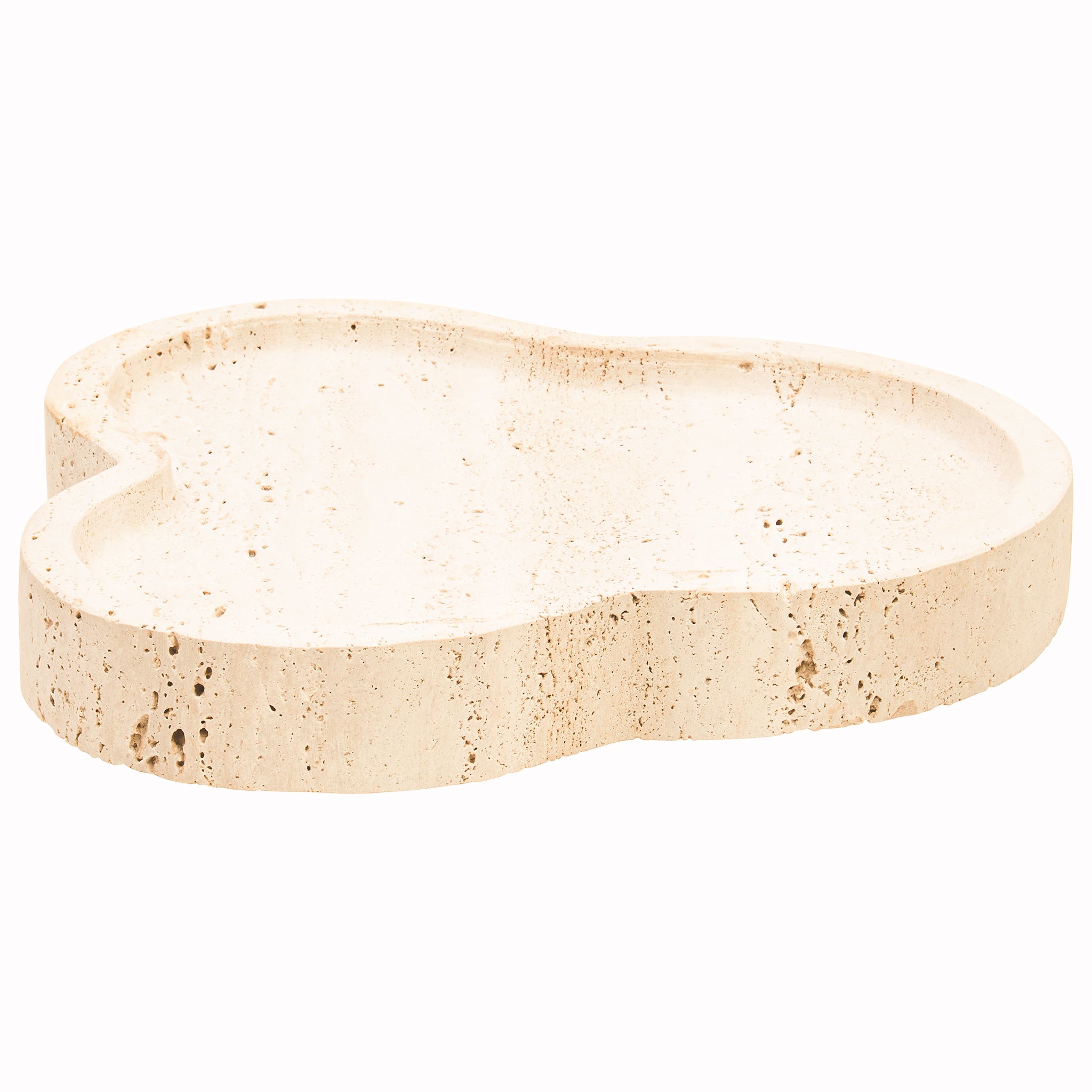 Angled view of the Noé Travertine Tray showing its flowing organic silhouette, recessed tray surface and warm beige naturally porous stone finish.