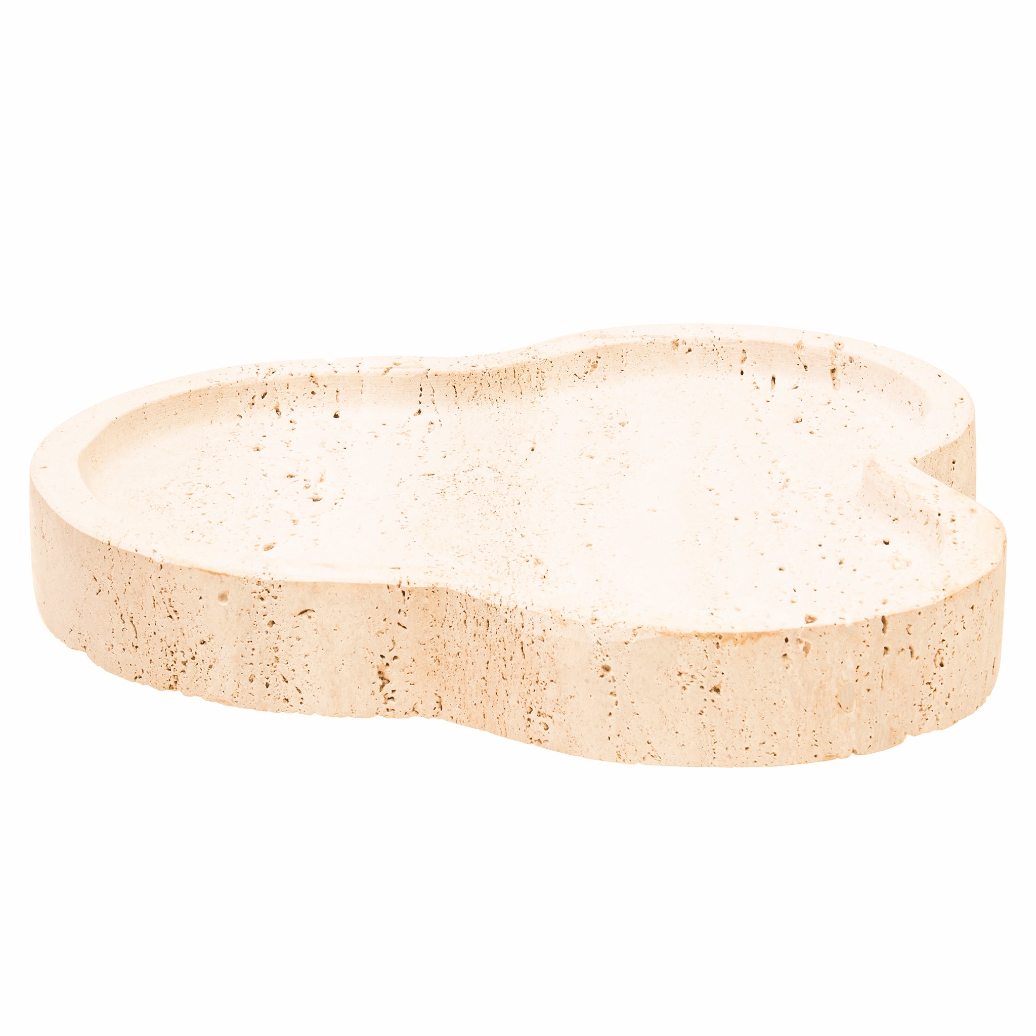 Side view of the Noé Travertine Tray showing its sculptural asymmetric shape, shallow recessed centre and thick naturally textured travertine stone edge.