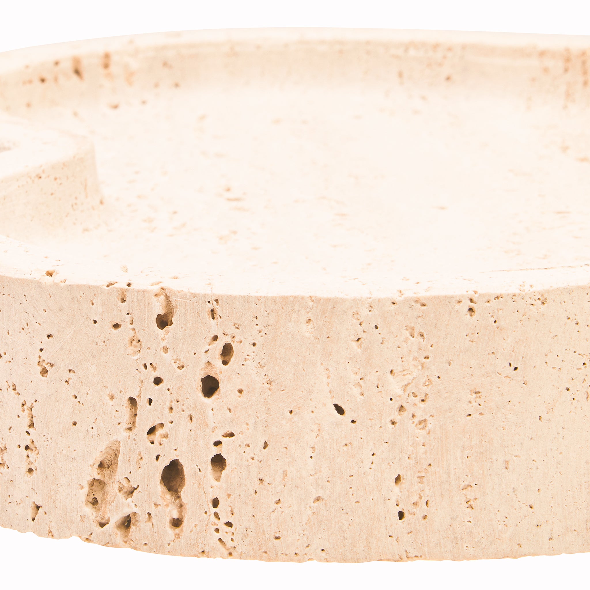 Extreme close-up of the Noé Travertine Tray highlighting the thick stone edge, organic curved surface and distinctive pores and markings of natural travertine.