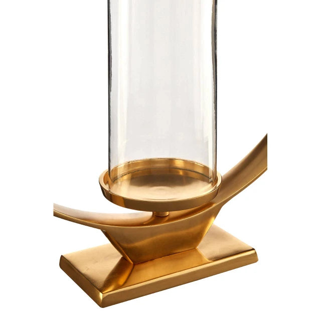 Close-up of Octave gold aluminium candle holder showing sculptural base and clear glass cylinder on white.
