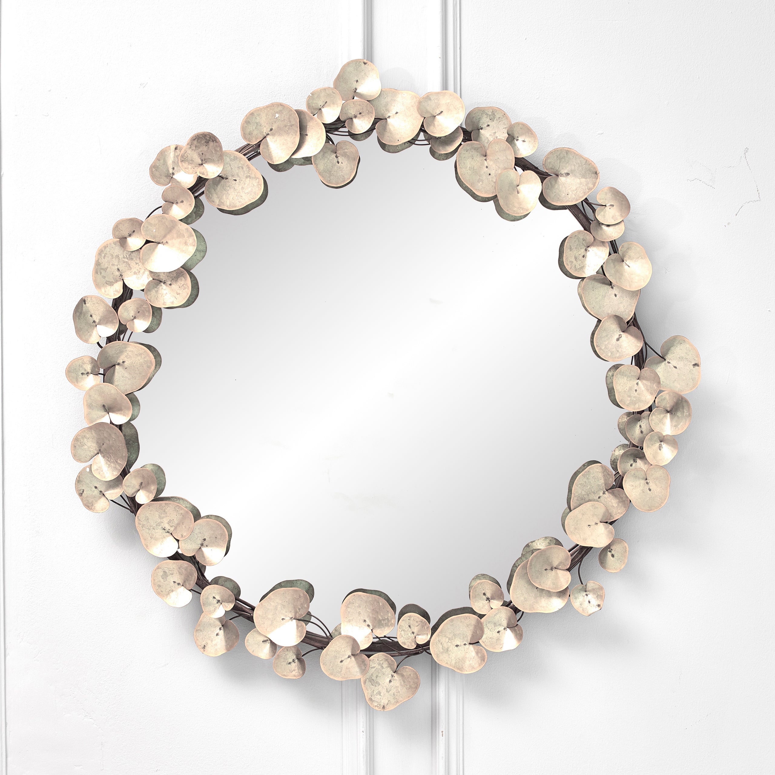 Front view of the Odette 109cm Round Wall Mirror featuring an antique white and gold floral metal frame with layered decorative leaf detailing, creating a luxury statement wall mirror for contemporary, classic and farmhouse interiors.