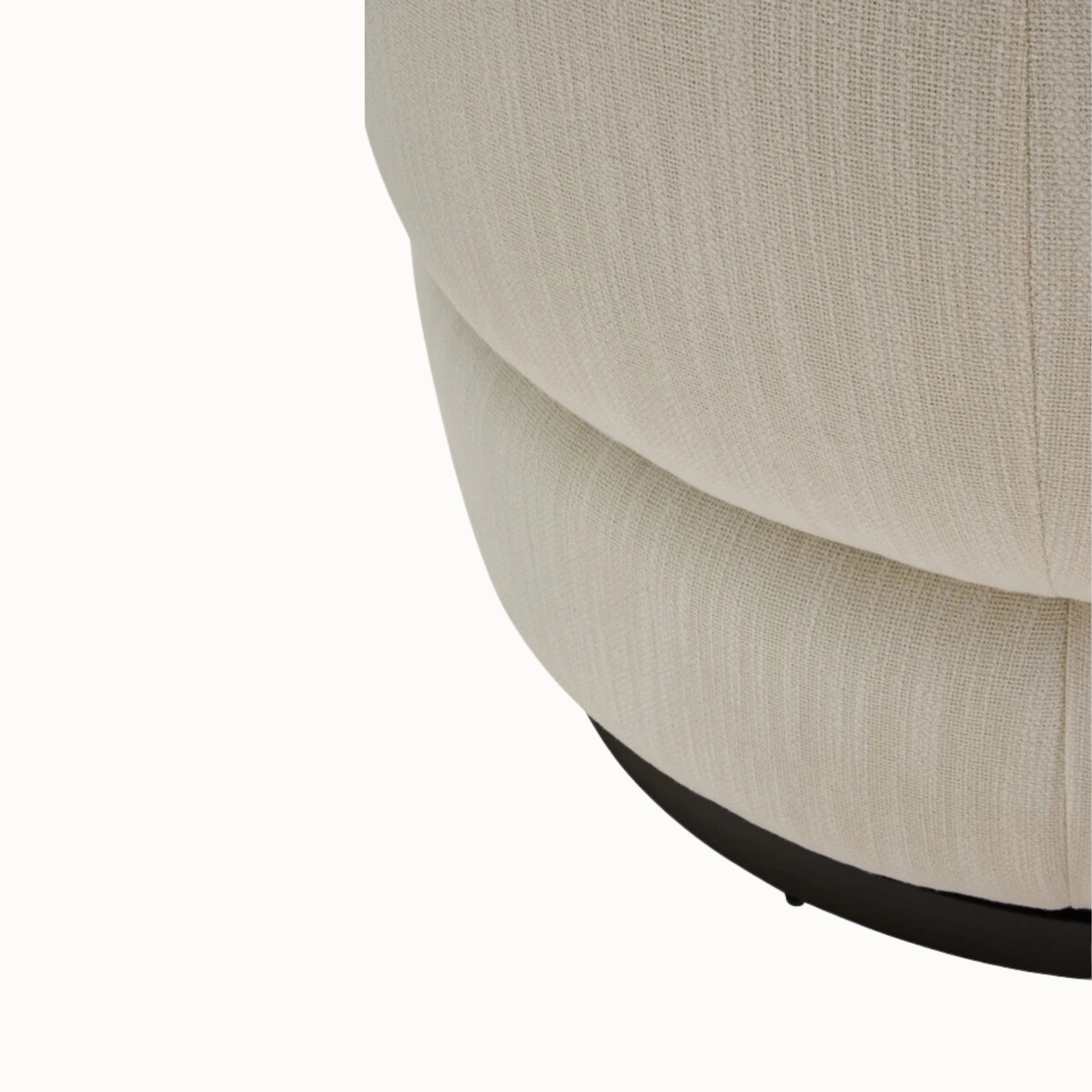 Close-up of Odile cream upholstered swivel armchair and black circular base against a plain white background