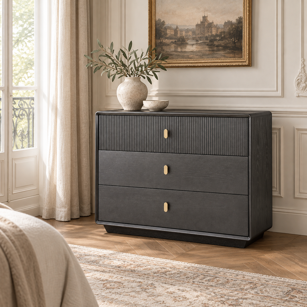 Oréliane brown grey wood veneer fluted 3 drawer chest in a sunlit bedroom with bed, rug, artwork and greenery.